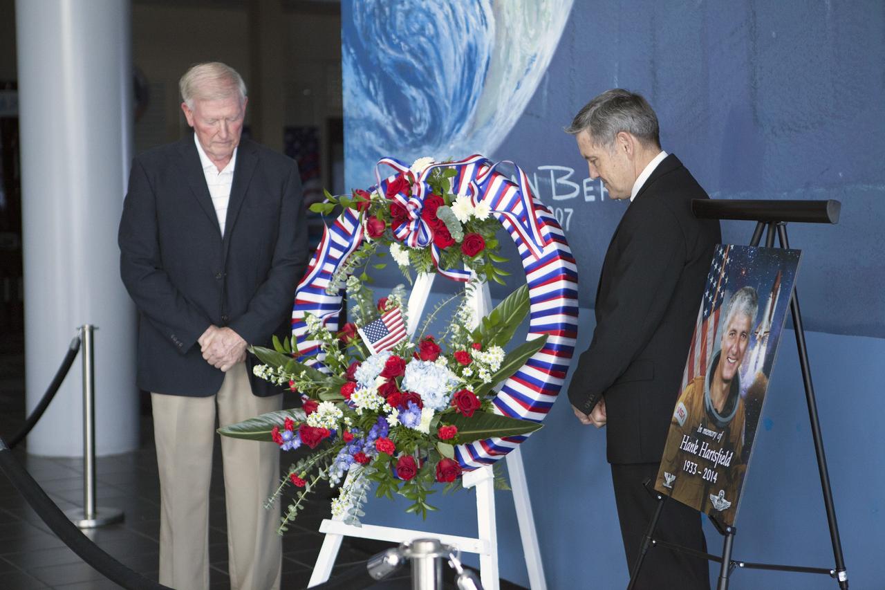 CAPE CANAVERAL, Fla. -- Former NASA astronaut Jon McBride, left, and Kennedy Space Center Director Bob Cabana pause for reflection after placing a wreath honoring Henry W. "Hank" Hartsfield at the U.S. Astronaut Hall of Fame.    Hartsfield commanded space shuttle Discovery's maiden mission and was a veteran of three shuttle flights. He died July 17 after an illness. He was 80 years old. Hartsfield joined NASA in 1969 and was part of the astronaut support crew for Apollo 16 and the Skylab 2, 3 and 4 missions. He logged 483 hours in space during missions STS-4, on which he served as pilot, as well as STS-41D and STS-61A, both of which he commanded. Photo credit: NASA/Dimitri Gerondidakis