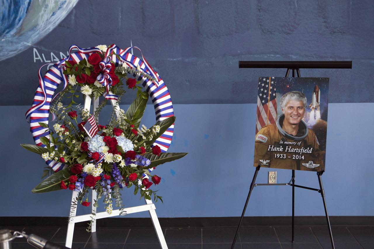 CAPE CANAVERAL, Fla. -- A wreath honoring Henry W. "Hank" Hartsfield is displayed beside his photo at the U.S. Astronaut Hall of Fame.    Hartsfield commanded space shuttle Discovery's maiden mission and was a veteran of three shuttle flights. He died July 17 after an illness. He was 80 years old. Hartsfield joined NASA in 1969 and was part of the astronaut support crew for Apollo 16 and the Skylab 2, 3 and 4 missions. He logged 483 hours in space during missions STS-4, on which he served as pilot, as well as STS-41D and STS-61A, both of which he commanded. Photo credit: NASA/Dimitri Gerondidakis