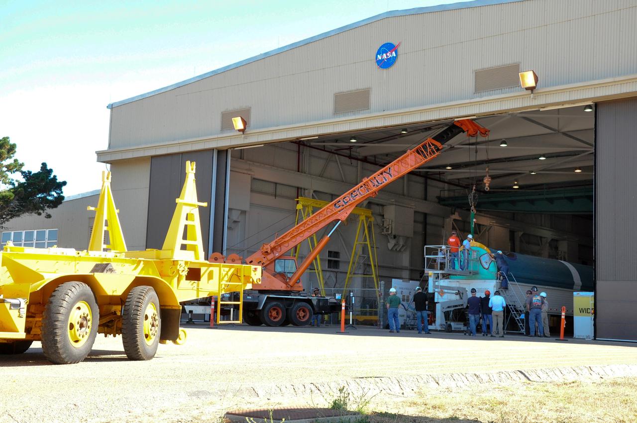 VANDENBERG AIR FORCE BASE, Calif. – A crane is positioned to offload the first stage of a United Launch Alliance Delta II rocket following its arrival at NASA hangar 836 on Vandenberg Air Force Base in California. The launch vehicle will be used to deliver NASA's Soil Moisture Active Passive mission, or SMAP, into orbit. SMAP will provide global measurements of soil moisture and its freeze/thaw state. These measurements will be used to enhance understanding of processes that link the water, energy and carbon cycles, and to extend the capabilities of weather and climate prediction models. SMAP data also will be used to quantify net carbon flux in boreal landscapes and to develop improved flood prediction and drought monitoring capabilities. Launch is scheduled for November 2014. To learn more about SMAP, visit http://smap.jpl.nasa.gov Photo credit: NASA/Randy Beaudoin