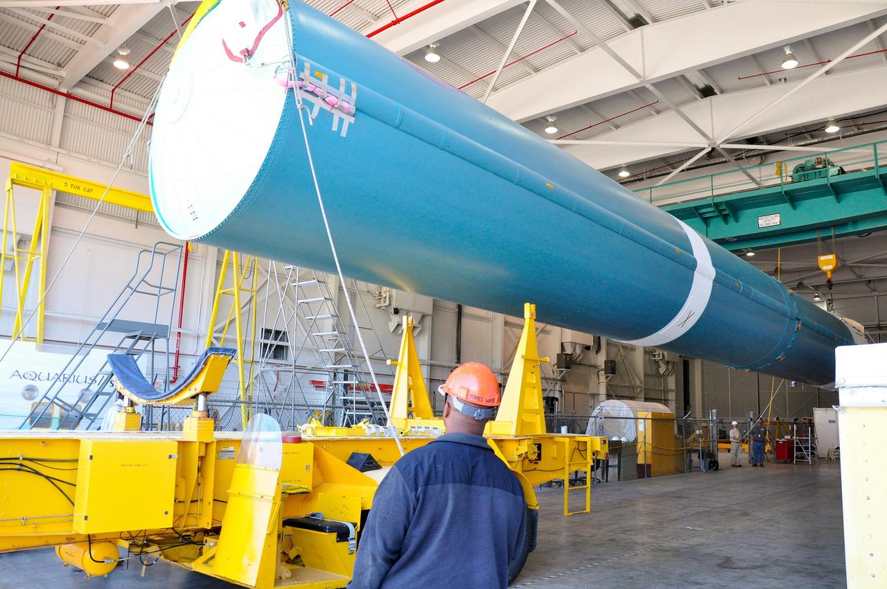 VANDENBERG AIR FORCE BASE, Calif. – Under the watchful eye of technicians, crane is used to offload the first stage of a United Launch Alliance Delta II rocket following its arrival at NASA hangar 836 on Vandenberg Air Force Base in California. The launch vehicle will be used to deliver NASA's Soil Moisture Active Passive mission, or SMAP, into orbit. SMAP will provide global measurements of soil moisture and its freeze/thaw state. These measurements will be used to enhance understanding of processes that link the water, energy and carbon cycles, and to extend the capabilities of weather and climate prediction models. SMAP data also will be used to quantify net carbon flux in boreal landscapes and to develop improved flood prediction and drought monitoring capabilities. Launch is scheduled for November 2014. To learn more about SMAP, visit http://smap.jpl.nasa.gov Photo credit: NASA/Randy Beaudoin