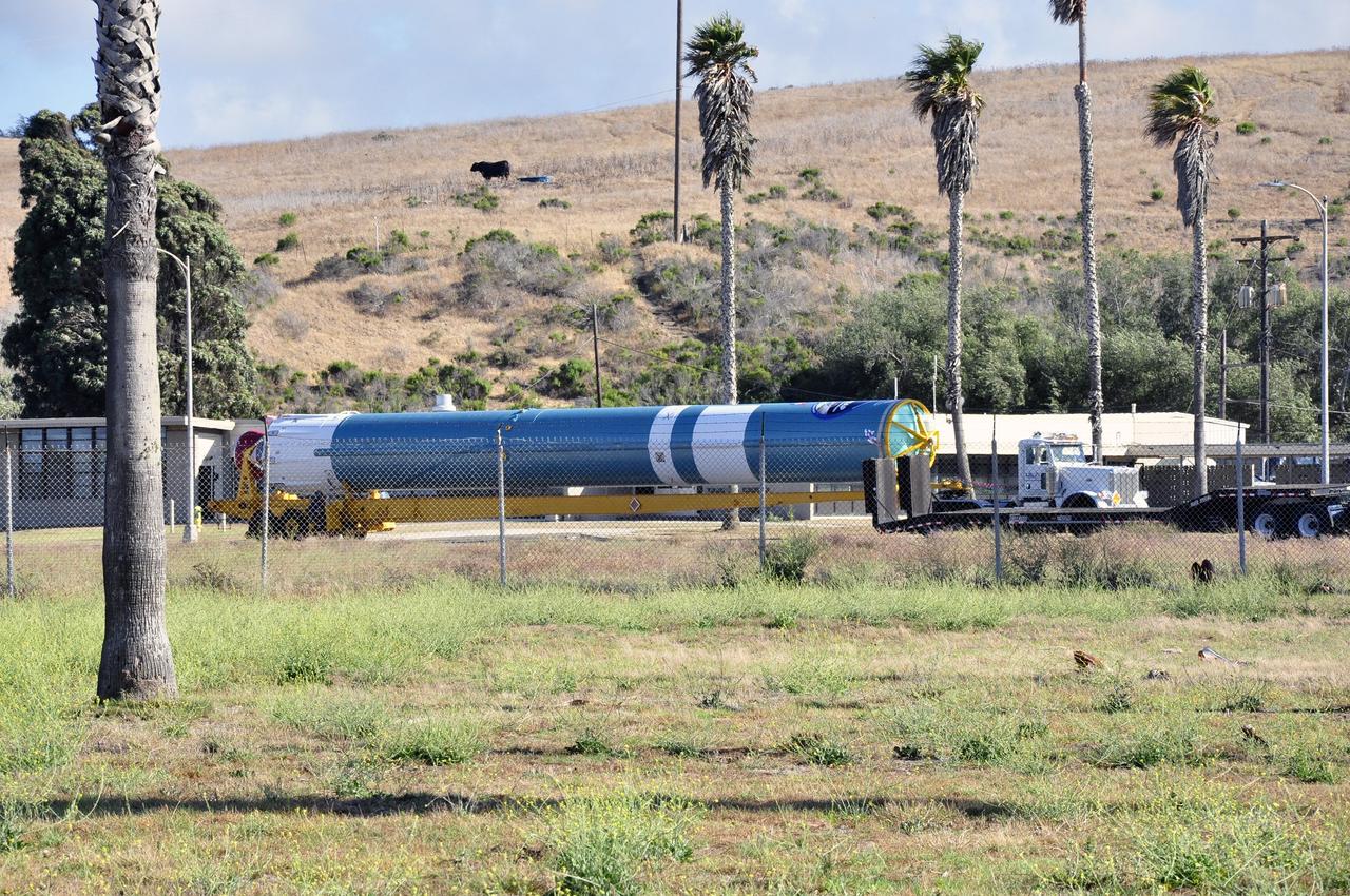 VANDENBERG AIR FORCE BASE, Calif. – The first stage of the United Launch Alliance Delta II rocket for NASA's Soil Moisture Active Passive mission, or SMAP, is transported from the Building 836 hangar to the Horizontal Processing Facility at Space Launch Complex 2 on Vandenberg Air Force Base in California.    SMAP will provide global measurements of soil moisture and its freeze/thaw state. These measurements will be used to enhance understanding of processes that link the water, energy and carbon cycles, and to extend the capabilities of weather and climate prediction models. SMAP data also will be used to quantify net carbon flux in boreal landscapes and to develop improved flood prediction and drought monitoring capabilities. Launch is scheduled for November 2014. To learn more about SMAP, visit http://smap.jpl.nasa.gov.  Photo credit: NASA/Randy Beaudoin