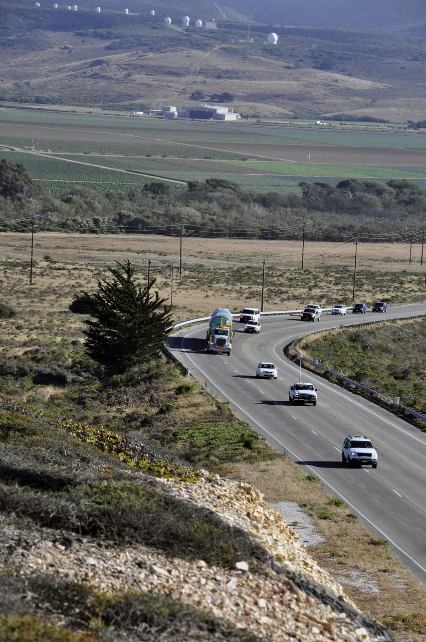 VANDENBERG AIR FORCE BASE, Calif. – A security detail travels with the first stage of the United Launch Alliance Delta II rocket for NASA's Soil Moisture Active Passive mission, or SMAP, on its move from the Building 836 hangar to the Horizontal Processing Facility at Space Launch Complex 2 on Vandenberg Air Force Base in California.    SMAP will provide global measurements of soil moisture and its freeze/thaw state. These measurements will be used to enhance understanding of processes that link the water, energy and carbon cycles, and to extend the capabilities of weather and climate prediction models. SMAP data also will be used to quantify net carbon flux in boreal landscapes and to develop improved flood prediction and drought monitoring capabilities. Launch is scheduled for November 2014. To learn more about SMAP, visit http://smap.jpl.nasa.gov.  Photo credit: NASA/Randy Beaudoin