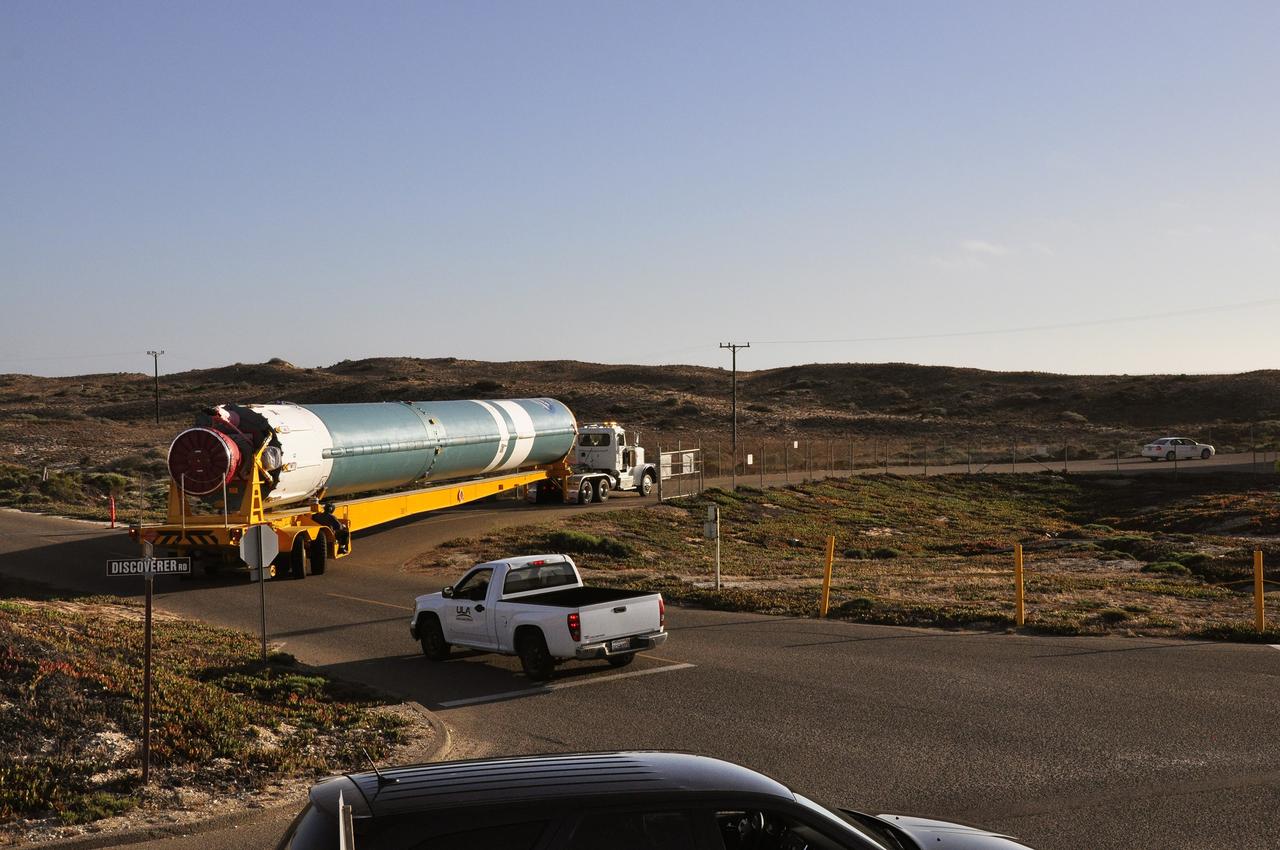VANDENBERG AIR FORCE BASE, Calif. – The first stage of the United Launch Alliance Delta II rocket for NASA's Soil Moisture Active Passive mission, or SMAP, accomplishes some tight turns on its approach to the Horizontal Processing Facility at Space Launch Complex 2 on Vandenberg Air Force Base in California.      SMAP will provide global measurements of soil moisture and its freeze/thaw state. These measurements will be used to enhance understanding of processes that link the water, energy and carbon cycles, and to extend the capabilities of weather and climate prediction models. SMAP data also will be used to quantify net carbon flux in boreal landscapes and to develop improved flood prediction and drought monitoring capabilities. Launch is scheduled for November 2014. To learn more about SMAP, visit http://smap.jpl.nasa.gov.  Photo credit: NASA/Randy Beaudoin