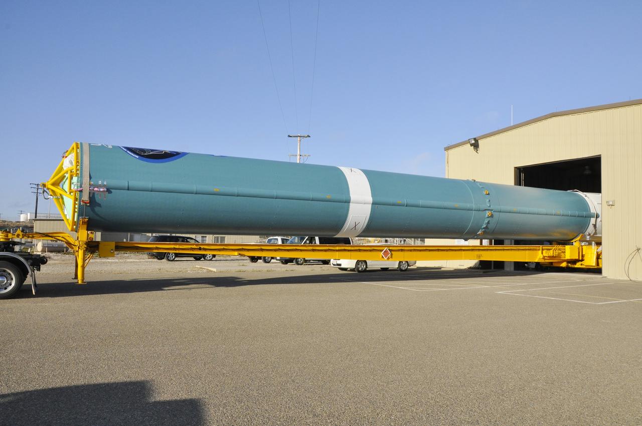 VANDENBERG AIR FORCE BASE, Calif. – The first stage of the United Launch Alliance Delta II rocket for NASA's Soil Moisture Active Passive mission, or SMAP, arrives at the Horizontal Processing Facility at Space Launch Complex 2 on Vandenberg Air Force Base in California.      SMAP will provide global measurements of soil moisture and its freeze/thaw state. These measurements will be used to enhance understanding of processes that link the water, energy and carbon cycles, and to extend the capabilities of weather and climate prediction models. SMAP data also will be used to quantify net carbon flux in boreal landscapes and to develop improved flood prediction and drought monitoring capabilities. Launch is scheduled for November 2014. To learn more about SMAP, visit http://smap.jpl.nasa.gov.  Photo credit: NASA/Randy Beaudoin