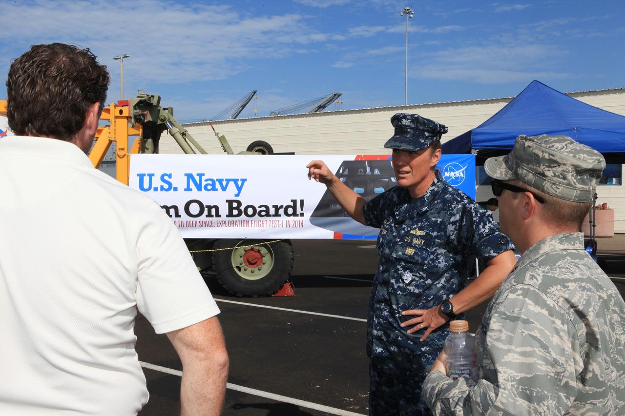 SAN DIEGO, Calif. – At the U.S. Naval Base San Diego in California, former NASA astronaut Heidi Piper talks with visitors about Exploration Flight Test-1 during an outreach event at the naval base. The USS Anchorage is being prepared for the Orion Underway Recovery Test 2. The Orion boilerplate test vehicle and other hardware will be loaded into the well deck of the ship and head out to sea in the Pacific Ocean off the coast of San Diego. NASA, Lockheed Martin and the U.S. Navy will conduct the test to prepare for recovery of the Orion crew module, forward bay cover and parachutes on its return from a deep space mission. The underway recovery test will allow the teams to demonstrate and evaluate the recovery processes, procedures, new support hardware and personnel in open waters.    The Ground Systems Development and Operations Program will conduct the underway recovery tests. Orion is the exploration spacecraft designed to carry astronauts to destinations not yet explored by humans, including an asteroid and Mars. It will have emergency abort capability, sustain the crew during space travel and provide safe re-entry from deep space return velocities. The first unpiloted test flight of the Orion is scheduled to launch in 2014 atop a Delta IV rocket and in 2017 on NASA’s Space Launch System rocket. For more information, visit http://www.nasa.gov/orion. Photo credit: NASA/Kim Shiflett