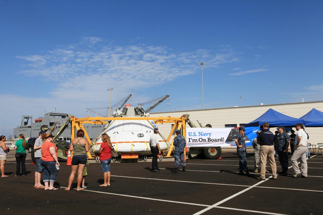 SAN DIEGO, Calif. – At the U.S. Naval Base San Diego in California, visitors talk with U.S. Navy personnel and view the Orion boilerplate test vehicle during an outreach event at the naval base. The USS Anchorage is being prepared for the Orion Underway Recovery Test 2. The test vehicle and other hardware will be loaded into the well deck of the ship and head out to sea in the Pacific Ocean off the coast of San Diego. NASA, Lockheed Martin and the U.S. Navy will conduct the test to prepare for recovery of the Orion crew module, forward bay cover and parachutes on its return from a deep space mission. The underway recovery test will allow the teams to demonstrate and evaluate the recovery processes, procedures, new support hardware and personnel in open waters.    The Ground Systems Development and Operations Program will conduct the underway recovery tests. Orion is the exploration spacecraft designed to carry astronauts to destinations not yet explored by humans, including an asteroid and Mars. It will have emergency abort capability, sustain the crew during space travel and provide safe re-entry from deep space return velocities. The first unpiloted test flight of the Orion is scheduled to launch in 2014 atop a Delta IV rocket and in 2017 on NASA’s Space Launch System rocket. For more information, visit http://www.nasa.gov/orion. Photo credit: NASA/Kim Shiflett