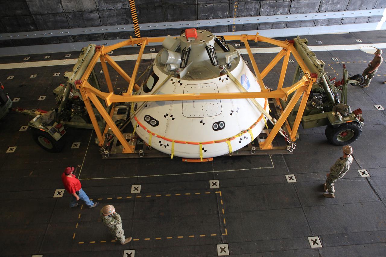SAN DIEGO, Calif. – At the U.S. Naval Base San Diego in California, NASA and U.S. Navy personnel make sure that the Orion boilerplate test vehicle and support hardware are secured in the well deck of the USS Anchorage for Underway Recovery Test 2. NASA, Lockheed Martin and the U.S. Navy will conduct tests in the Pacific Ocean to prepare for recovery of the Orion crew module, forward bay cover and parachutes on its return from a deep space mission. The second underway recovery test will allow the teams to demonstrate and evaluate the recovery processes, procedures, new hardware and personnel in open waters.    The Ground Systems Development and Operations Program is conducting the underway recovery tests. Orion is the exploration spacecraft designed to carry astronauts to destinations not yet explored by humans, including an asteroid and Mars. It will have emergency abort capability, sustain the crew during space travel and provide safe re-entry from deep space return velocities. The first unpiloted test flight of the Orion is scheduled to launch in 2014 atop a Delta IV rocket and in 2017 on NASA’s Space Launch System rocket. For more information, visit http://www.nasa.gov/orion. Photo credit: NASA/Kim Shiflett