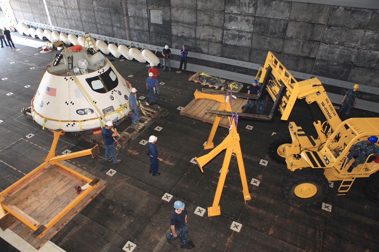 SAN DIEGO, Calif. – NASA, Lockheed Martin and U.S. Navy personnel remove the handling fixture from the Orion boilerplate test vehicle in the well deck of the USS Anchorage at the U.S. Naval Base San Diego, to prepare for Underway Recovery Test 2. The ship will head out to sea, off the coast of San Diego, in search of conditions to support test needs. The team will conduct tests in the Pacific Ocean to prepare for recovery of the Orion crew module on its return from a deep space mission. The second underway recovery test will allow the teams to demonstrate and evaluate the recovery processes, procedures, new hardware and personnel in open waters.    The Ground Systems Development and Operations Program is conducting the underway recovery tests. Orion is the exploration spacecraft designed to carry astronauts to destinations not yet explored by humans, including an asteroid and Mars. It will have emergency abort capability, sustain the crew during space travel and provide safe re-entry from deep space return velocities. The first unpiloted test flight of the Orion is scheduled to launch in 2014 atop a Delta IV rocket and in 2017 on NASA’s Space Launch System rocket. For more information, visit http://www.nasa.gov/orion. Photo credit: NASA/Kim Shiflett