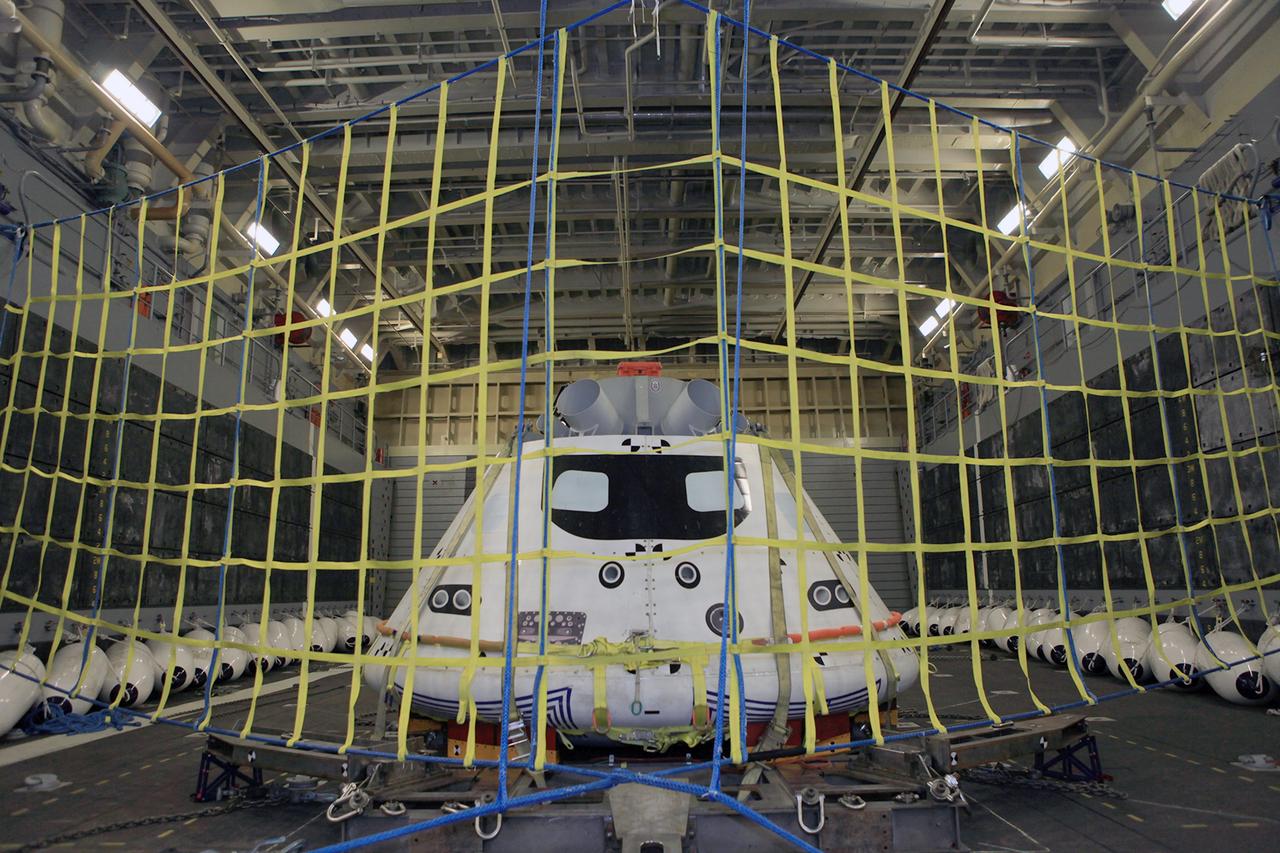 SAN DIEGO, Calif. – The Orion boilerplate test vehicle is secured on its cradle in the well deck of the U.S. Navy's USS Anchorage in preparation for Underway Recovery Test 2 in the Pacific Ocean off the coast of San Diego. NASA, Lockheed Martin and the U.S. Navy will conduct the test to prepare for recovery of the Orion crew module on its return from a deep space mission. The underway recovery test will allow the team to demonstrate and evaluate the recovery processes, procedures, new hardware and personnel in open waters. The Ground Systems Development and Operations Program is conducting the underway recovery test. Orion is the exploration spacecraft designed to carry astronauts to destinations not yet explored by humans, including an asteroid and Mars. It will have emergency abort capability, sustain the crew during space travel and provide safe re-entry from deep space return velocities. The first unpiloted test flight of the Orion is scheduled to launch in 2014 atop a Delta IV rocket and in 2017 on NASA’s Space Launch System rocket. For more information, visit http://www.nasa.gov/orion. Photo credit: NASA/Kim Shiflett