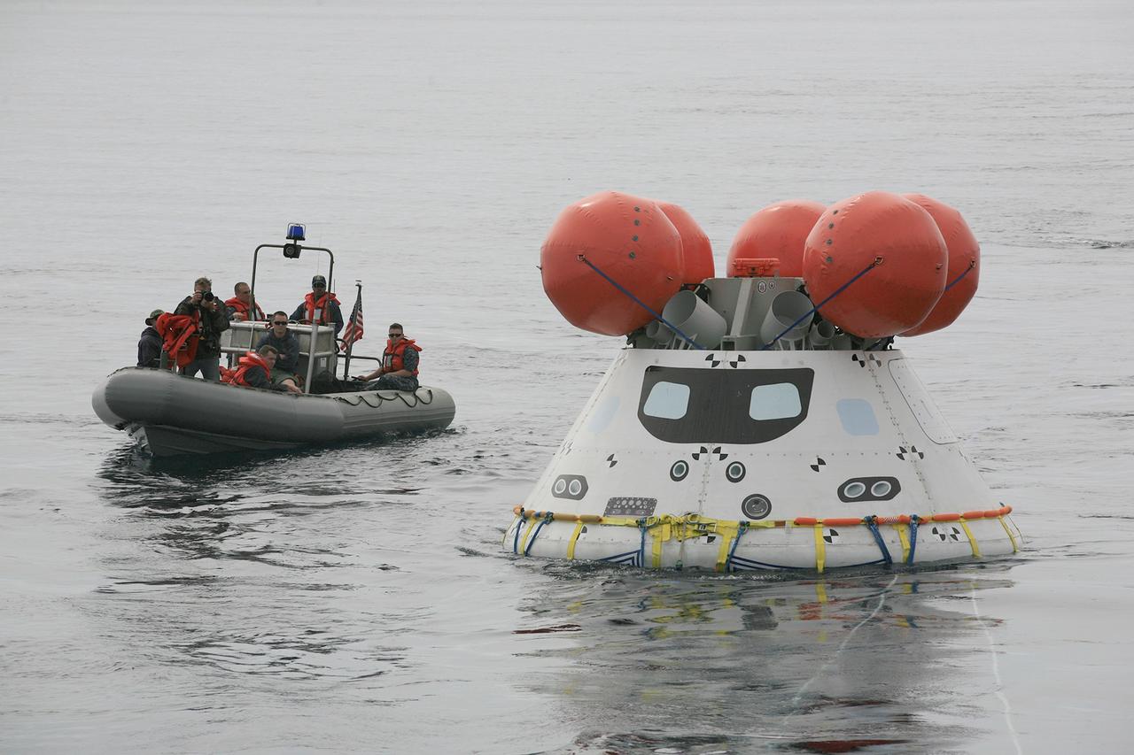 SAN DIEGO, Calif. – U.S. Navy personnel use a rigid hull inflatable boat to approach the Orion boilerplate test article during an evolution of the Underway Recovery Test 2 in the Pacific Ocean off the coast of San Diego. During the test, the vehicle was released from the well deck of the USS Anchorage and allowed to float freely in the water. NASA, Lockheed Martin and the U.S. Navy are conducting the test to prepare for recovery of the Orion crew module on its return from a deep space mission. The underway recovery test will allow the team to demonstrate and evaluate the recovery processes, procedures, new hardware and personnel in open waters. The Ground Systems Development and Operations Program is conducting the underway recovery test. Orion is the exploration spacecraft designed to carry astronauts to destinations not yet explored by humans, including an asteroid and Mars. It will have emergency abort capability, sustain the crew during space travel and provide safe re-entry from deep space return velocities. The first unpiloted test flight of the Orion is scheduled to launch in 2014 atop a Delta IV rocket and in 2017 on NASA’s Space Launch System rocket. For more information, visit http://www.nasa.gov/orion. Photo credit: NASA/Kim Shiflett