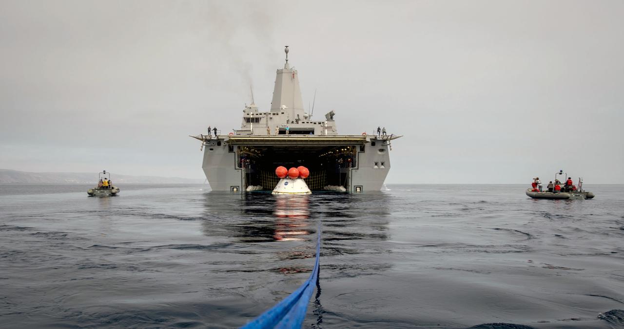 SAN DIEGO, Calif. – U.S. Navy personnel in rigid hull inflatable boats practice with tether lines attached to the Orion boilerplate test vehicle during an evolution of the Underway Recovery Test 2 near the USS Anchorage in the Pacific Ocean off the coast of San Diego. The vehicle is outside of the ship. NASA, Lockheed Martin and the U.S. Navy are conducting the test to prepare for recovery of the Orion crew module on its return from a deep space mission. The underway recovery test will allow the teams to demonstrate and evaluate the recovery processes, procedures, new hardware and personnel in open waters. The Ground Systems Development and Operations Program is conducting the underway recovery test. Orion is the exploration spacecraft designed to carry astronauts to destinations not yet explored by humans, including an asteroid and Mars. It will have emergency abort capability, sustain the crew during space travel and provide safe re-entry from deep space return velocities. The first unpiloted test flight of the Orion is scheduled to launch in 2014 atop a Delta IV rocket and in 2017 on NASA’s Space Launch System rocket. For more information, visit http://www.nasa.gov/orion. Photo credit: U.S. Navy/Specialist 1st Class Gary Keen