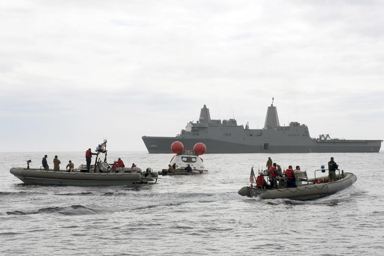 SAN DIEGO, Calif. – U.S. Navy personnel, in rigid hull inflatable boats, monitor the Orion boilerplate test vehicle as it floats freely near the USS Anchorage in the Pacific Ocean off the coast of San Diego during an evolution of the Underway Recovery Test 2. NASA, Lockheed Martin and the U.S. Navy are conducting the test to prepare for recovery of the Orion crew module on its return from a deep space mission. The underway recovery test will allow the teams to demonstrate and evaluate the recovery processes, procedures, new hardware and personnel in open waters. The Ground Systems Development and Operations Program is conducting the underway recovery test. Orion is the exploration spacecraft designed to carry astronauts to destinations not yet explored by humans, including an asteroid and Mars. It will have emergency abort capability, sustain the crew during space travel and provide safe re-entry from deep space return velocities. The first unpiloted test flight of the Orion is scheduled to launch in 2014 atop a Delta IV rocket and in 2017 on NASA’s Space Launch System rocket. For more information, visit http://www.nasa.gov/orion. Photo credit: NASA/Kenny Allen