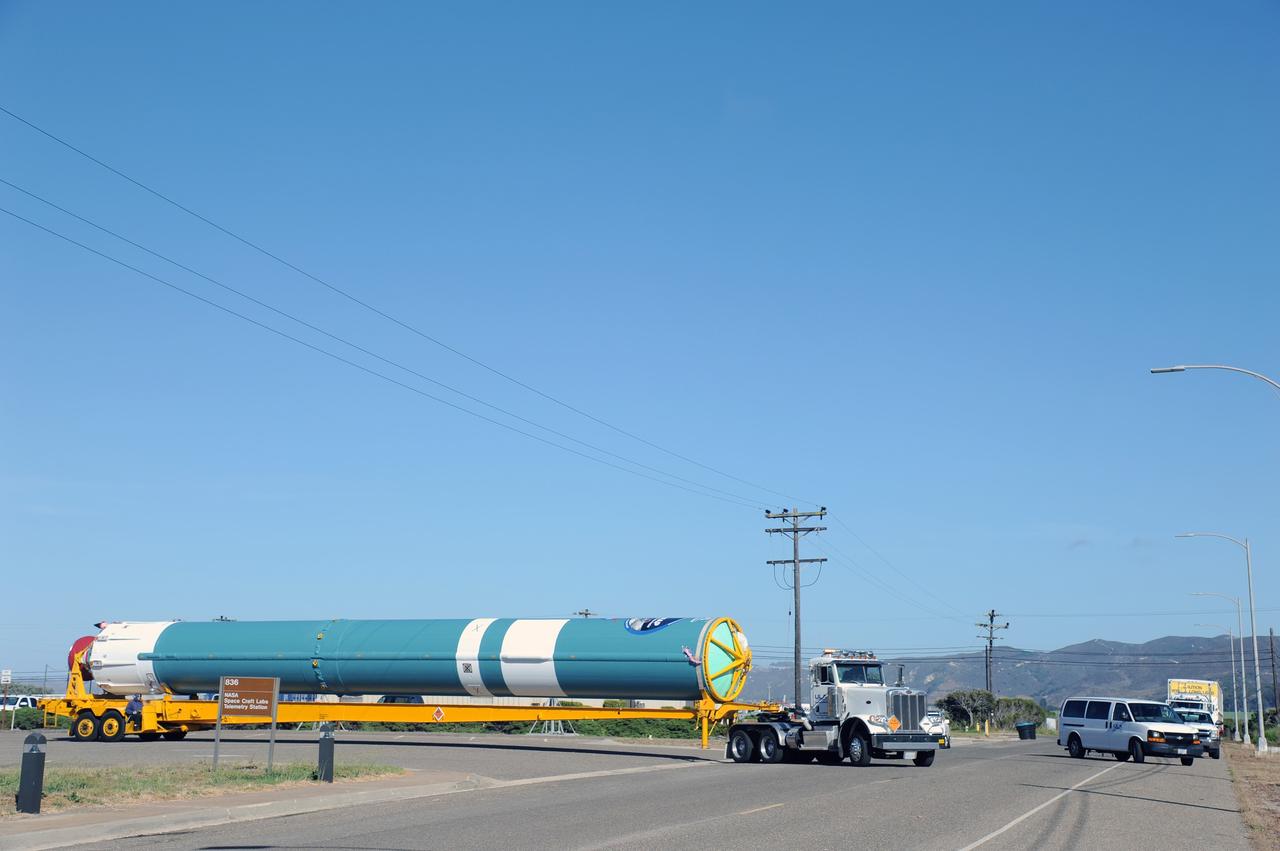 VANDENBERG AIR FORCE BASE, Calif. – The first stage of the United Launch Alliance Delta II rocket for NASA's Soil Moisture Active Passive mission, or SMAP, is transported from the Building 836 hangar to the Horizontal Processing Facility at Space Launch Complex 2 on Vandenberg Air Force Base in California.    SMAP will provide global measurements of soil moisture and its freeze/thaw state. These measurements will be used to enhance understanding of processes that link the water, energy and carbon cycles, and to extend the capabilities of weather and climate prediction models. SMAP data also will be used to quantify net carbon flux in boreal landscapes and to develop improved flood prediction and drought monitoring capabilities. Launch is scheduled for November 2014. To learn more about SMAP, visit http://smap.jpl.nasa.gov.  Photo credit: NASA/U.S. Air Force 30th Space Wing