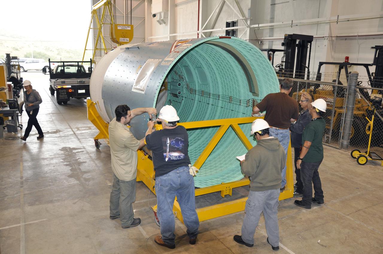 VANDENBERG AIR FORCE BASE, Calif. – The Delta II interstage adapter, or ISA, for NASA's Soil Moisture Active Passive mission, or SMAP, is attached to a lifting device in the Building 836 hangar on south Vandenberg Air Force Base in California during preparations for its move to the pad.       A United Launch Alliance Delta II rocket will loft SMAP into orbit from Vandenberg's Space Launch Complex 2. The ISA connects the Delta II first and second stages and encloses the second stage engine and thrust section. The spacecraft will provide global measurements of soil moisture and its freeze/thaw state. These measurements will be used to enhance understanding of processes that link the water, energy and carbon cycles, and to extend the capabilities of weather and climate prediction models. The data returned also will be used to quantify net carbon flux in boreal landscapes and to develop improved flood prediction and drought monitoring capabilities. Launch is scheduled for November 2014. To learn more about SMAP, visit http://smap.jpl.nasa.gov.  Photo credit: NASA/Randy Beaudoin