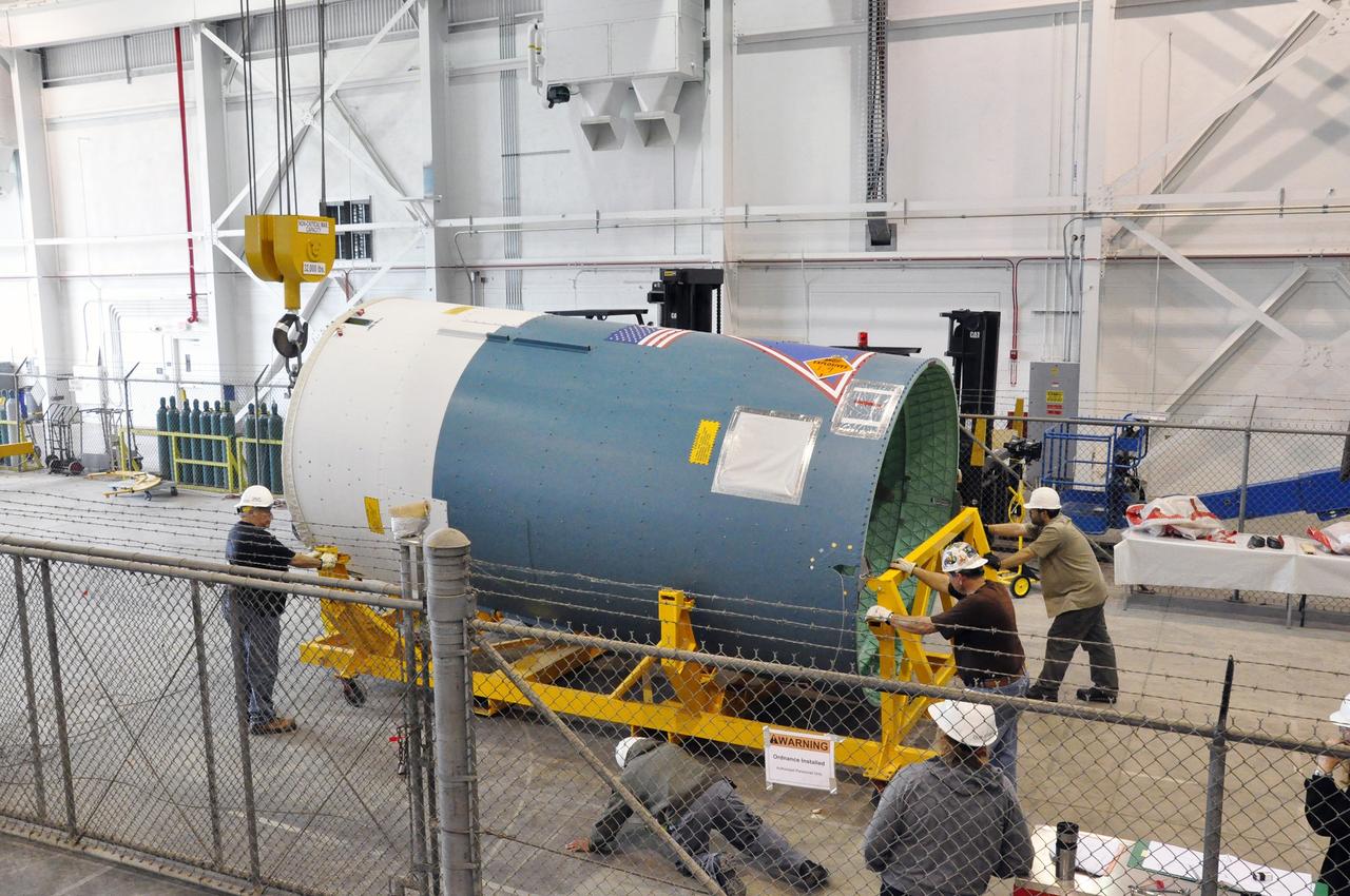 VANDENBERG AIR FORCE BASE, Calif. – Workers prepare to raise the Delta II interstage adapter, or ISA, for NASA's Soil Moisture Active Passive mission, or SMAP, into a vertical position in the Building 836 hangar on south Vandenberg Air Force Base in California during preparations for its move to the pad.    A United Launch Alliance Delta II rocket will loft SMAP into orbit from Vandenberg's Space Launch Complex 2. The ISA connects the Delta II first and second stages and encloses the second stage engine and thrust section. The spacecraft will provide global measurements of soil moisture and its freeze/thaw state. These measurements will be used to enhance understanding of processes that link the water, energy and carbon cycles, and to extend the capabilities of weather and climate prediction models. The data returned also will be used to quantify net carbon flux in boreal landscapes and to develop improved flood prediction and drought monitoring capabilities. Launch is scheduled for November 2014. To learn more about SMAP, visit http://smap.jpl.nasa.gov.  Photo credit: NASA/Randy Beaudoin