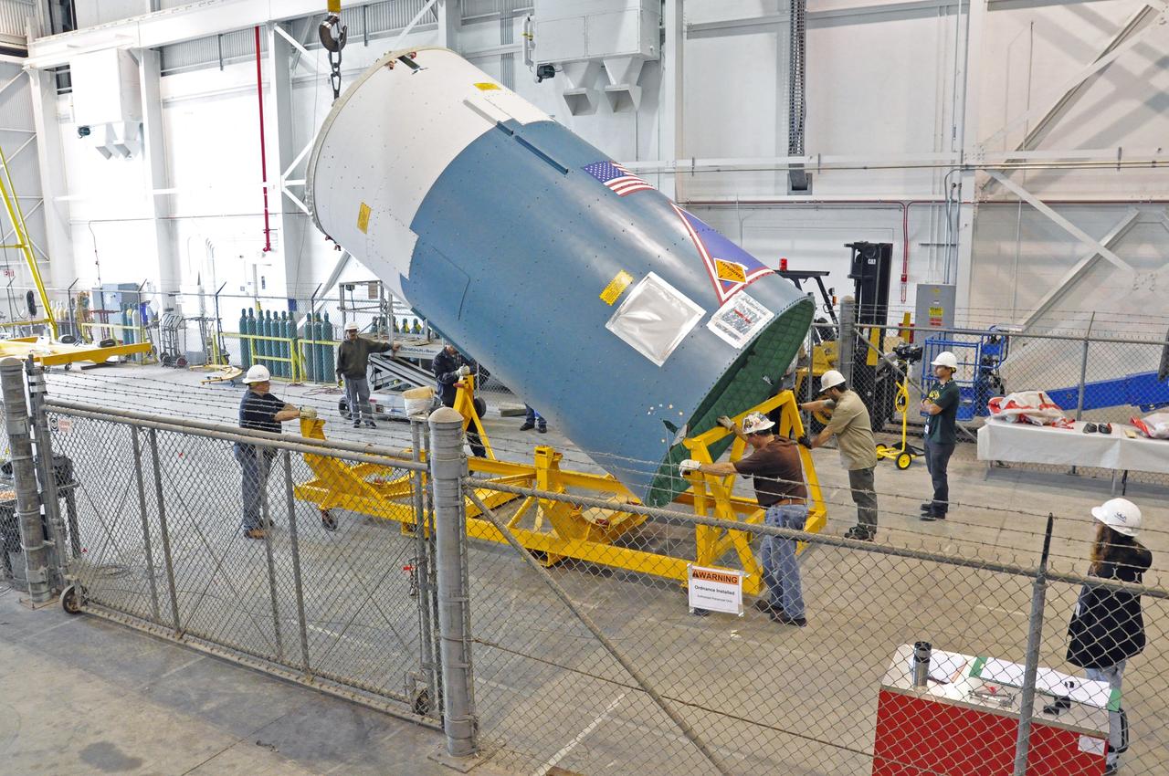 VANDENBERG AIR FORCE BASE, Calif. – Workers raise the Delta II interstage adapter, or ISA, for NASA's Soil Moisture Active Passive mission, or SMAP, into a vertical position in the Building 836 hangar on south Vandenberg Air Force Base in California during preparations for its move to the pad.    A United Launch Alliance Delta II rocket will loft SMAP into orbit from Vandenberg's Space Launch Complex 2. The ISA connects the Delta II first and second stages and encloses the second stage engine and thrust section. The spacecraft will provide global measurements of soil moisture and its freeze/thaw state. These measurements will be used to enhance understanding of processes that link the water, energy and carbon cycles, and to extend the capabilities of weather and climate prediction models. The data returned also will be used to quantify net carbon flux in boreal landscapes and to develop improved flood prediction and drought monitoring capabilities. Launch is scheduled for November 2014. To learn more about SMAP, visit http://smap.jpl.nasa.gov.  Photo credit: NASA/Randy Beaudoin