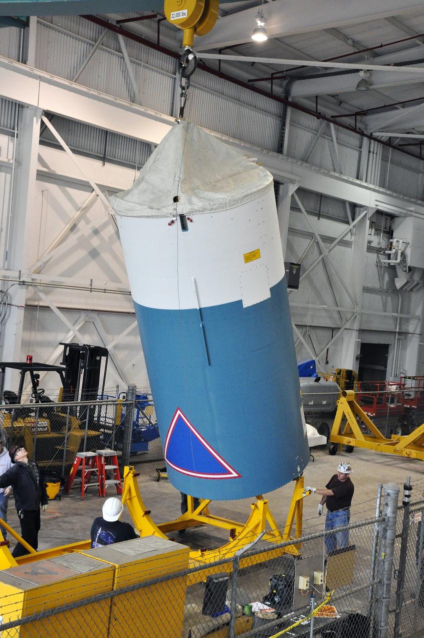 VANDENBERG AIR FORCE BASE, Calif. – A crane lifts the Delta II interstage adapter, or ISA, for NASA's Soil Moisture Active Passive mission, or SMAP, off its stand into a vertical position in the Building 836 hangar on south Vandenberg Air Force Base in California during preparations for its move to the pad.      A United Launch Alliance Delta II rocket will loft SMAP into orbit from Vandenberg's Space Launch Complex 2. The ISA connects the Delta II first and second stages and encloses the second stage engine and thrust section. The spacecraft will provide global measurements of soil moisture and its freeze/thaw state. These measurements will be used to enhance understanding of processes that link the water, energy and carbon cycles, and to extend the capabilities of weather and climate prediction models. The data returned also will be used to quantify net carbon flux in boreal landscapes and to develop improved flood prediction and drought monitoring capabilities. Launch is scheduled for November 2014. To learn more about SMAP, visit http://smap.jpl.nasa.gov.  Photo credit: NASA/Randy Beaudoin