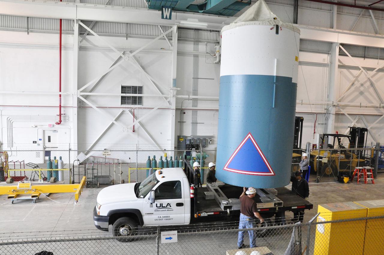 VANDENBERG AIR FORCE BASE, Calif. – The Delta II interstage adapter, or ISA, for NASA's Soil Moisture Active Passive mission, or SMAP, is lowered onto the flatbed of the truck that will transport it from the Building 836 hangar on south Vandenberg Air Force Base in California to the pad.      A United Launch Alliance Delta II rocket will loft SMAP into orbit from Vandenberg's Space Launch Complex 2. The ISA connects the Delta II first and second stages and encloses the second stage engine and thrust section. The spacecraft will provide global measurements of soil moisture and its freeze/thaw state. These measurements will be used to enhance understanding of processes that link the water, energy and carbon cycles, and to extend the capabilities of weather and climate prediction models. The data returned also will be used to quantify net carbon flux in boreal landscapes and to develop improved flood prediction and drought monitoring capabilities. Launch is scheduled for November 2014. To learn more about SMAP, visit http://smap.jpl.nasa.gov.  Photo credit: NASA/Randy Beaudoin