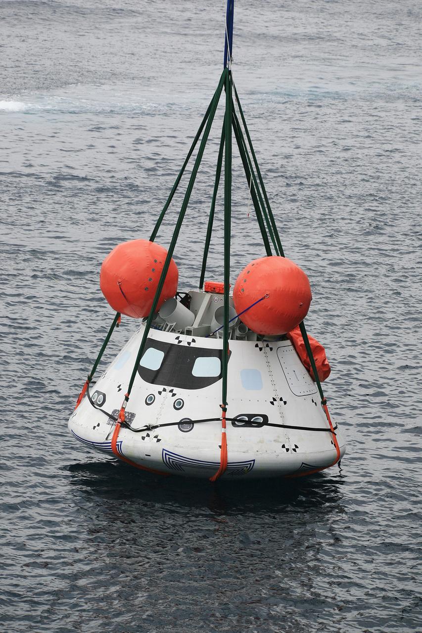SAN DIEGO, Calif. – The Orion boilerplate test vehicle is slightly lifted by crane from the water to test the proof of concept basket lift method during an evolution of the Underway Recovery Test near the USS Anchorage in the Pacific Ocean off the coast of San Diego. NASA, Lockheed Martin and the U.S. Navy are conducting the test to prepare for recovery of the Orion crew module on its return from a deep space mission. The underway recovery test will allow the teams to demonstrate and evaluate the recovery processes, procedures, new hardware and personnel in open waters.     The Ground Systems Development and Operations Program is conducting the underway recovery test. Orion is the exploration spacecraft designed to carry astronauts to destinations not yet explored by humans, including an asteroid and Mars. It will have emergency abort capability, sustain the crew during space travel and provide safe re-entry from deep space return velocities. The first unpiloted test flight of the Orion is scheduled to launch in 2014 atop a Delta IV rocket and in 2017 on NASA’s Space Launch System rocket. For more information, visit http://www.nasa.gov/orion. Photo credit: NASA/Kim Shiflett