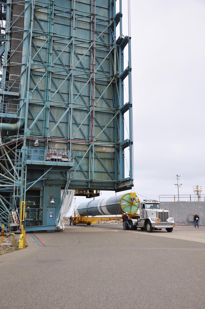 VANDENBERG AIR FORCE BASE, Calif. – The first stage of the United Launch Alliance Delta II rocket for NASA's Soil Moisture Active Passive mission, or SMAP, is delivered to the base of the mobile service tower at Space Launch Complex 2 on Vandenberg Air Force Base in California. SMAP will provide global measurements of soil moisture and its freeze/thaw state. These measurements will be used to enhance understanding of processes that link the water, energy and carbon cycles, and to extend the capabilities of weather and climate prediction models. SMAP data also will be used to quantify net carbon flux in boreal landscapes and to develop improved flood prediction and drought monitoring capabilities. Launch is scheduled for November 2014. To learn more about SMAP, visit http://smap.jpl.nasa.gov. Photo credit: NASA/Randy Beaudoin