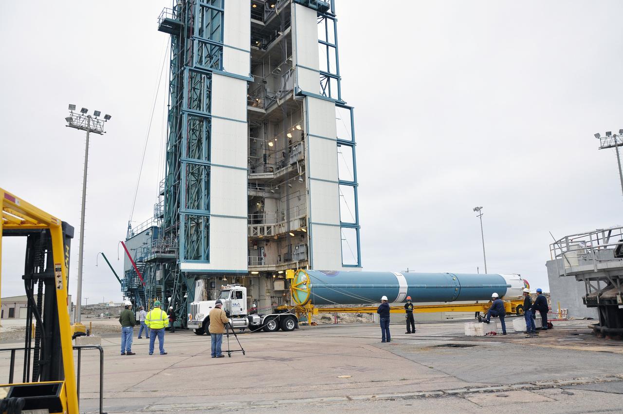 VANDENBERG AIR FORCE BASE, Calif. – Workers oversee the preparations to lift the first stage of the United Launch Alliance Delta II rocket for NASA's Soil Moisture Active Passive mission, or SMAP, into the mobile service tower at Space Launch Complex 2 on Vandenberg Air Force Base in California.    SMAP will provide global measurements of soil moisture and its freeze/thaw state. These measurements will be used to enhance understanding of processes that link the water, energy and carbon cycles, and to extend the capabilities of weather and climate prediction models. SMAP data also will be used to quantify net carbon flux in boreal landscapes and to develop improved flood prediction and drought monitoring capabilities. Launch is scheduled for November 2014. To learn more about SMAP, visit http://smap.jpl.nasa.gov.  Photo credit: NASA/Randy Beaudoin