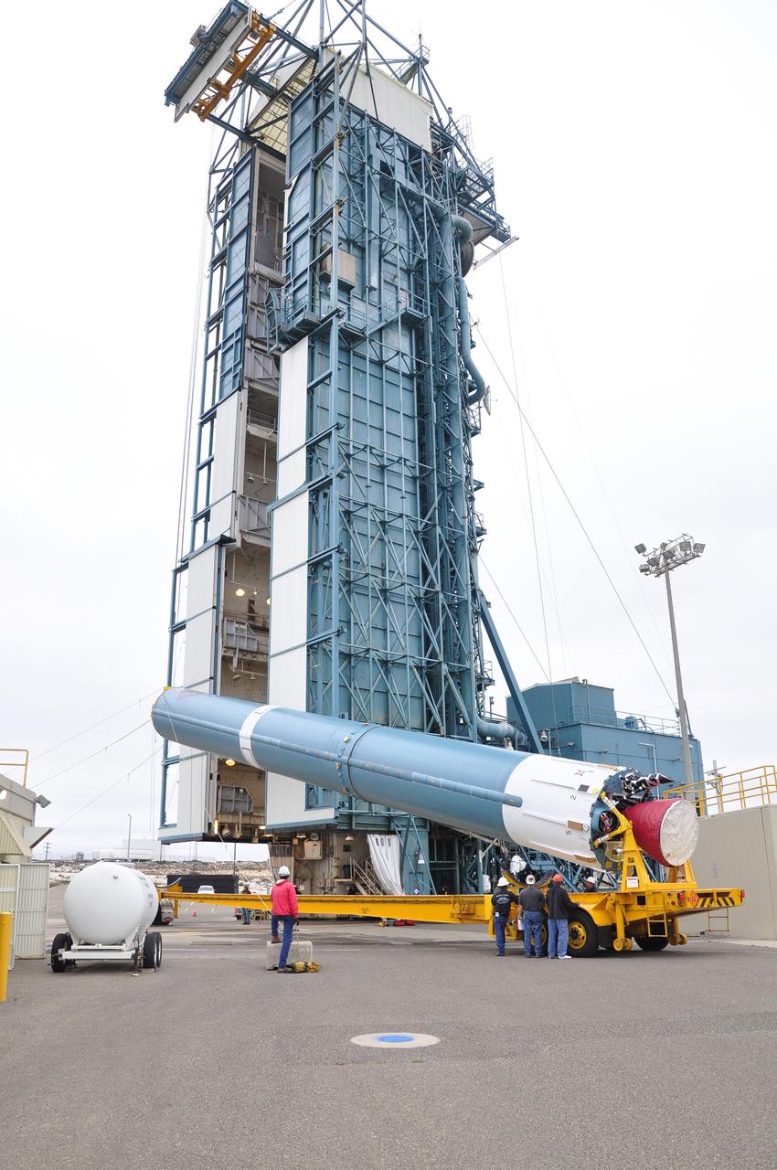 VANDENBERG AIR FORCE BASE, Calif. – The first stage of the United Launch Alliance Delta II rocket for NASA's Soil Moisture Active Passive mission, or SMAP, is elevated off its transporter into a vertical position for its move into the mobile service tower at Space Launch Complex 2 on Vandenberg Air Force Base in California.    SMAP will provide global measurements of soil moisture and its freeze/thaw state. These measurements will be used to enhance understanding of processes that link the water, energy and carbon cycles, and to extend the capabilities of weather and climate prediction models. SMAP data also will be used to quantify net carbon flux in boreal landscapes and to develop improved flood prediction and drought monitoring capabilities. Launch is scheduled for November 2014. To learn more about SMAP, visit http://smap.jpl.nasa.gov.  Photo credit: NASA/Randy Beaudoin