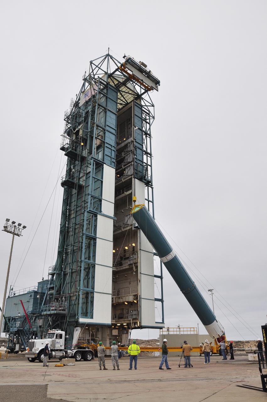 VANDENBERG AIR FORCE BASE, Calif. – The first stage of the United Launch Alliance Delta II rocket for NASA's Soil Moisture Active Passive mission, or SMAP, is hoisted into a vertical position for its move into the mobile service tower at Space Launch Complex 2 on Vandenberg Air Force Base in California.    SMAP will provide global measurements of soil moisture and its freeze/thaw state. These measurements will be used to enhance understanding of processes that link the water, energy and carbon cycles, and to extend the capabilities of weather and climate prediction models. SMAP data also will be used to quantify net carbon flux in boreal landscapes and to develop improved flood prediction and drought monitoring capabilities. Launch is scheduled for November 2014. To learn more about SMAP, visit http://smap.jpl.nasa.gov.  Photo credit: NASA/Randy Beaudoin