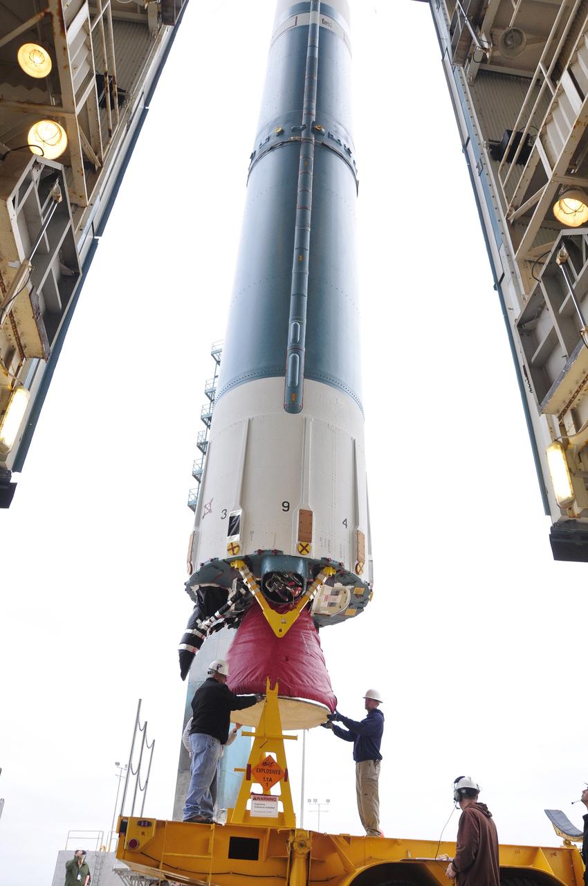 VANDENBERG AIR FORCE BASE, Calif. – Workers steady the first stage of the United Launch Alliance Delta II rocket for NASA's Soil Moisture Active Passive mission, or SMAP, after it is lifted into a vertical position beside the mobile service tower at Space Launch Complex 2 on Vandenberg Air Force Base in California.    SMAP will provide global measurements of soil moisture and its freeze/thaw state. These measurements will be used to enhance understanding of processes that link the water, energy and carbon cycles, and to extend the capabilities of weather and climate prediction models. SMAP data also will be used to quantify net carbon flux in boreal landscapes and to develop improved flood prediction and drought monitoring capabilities. Launch is scheduled for November 2014. To learn more about SMAP, visit http://smap.jpl.nasa.gov.  Photo credit: NASA/Randy Beaudoin