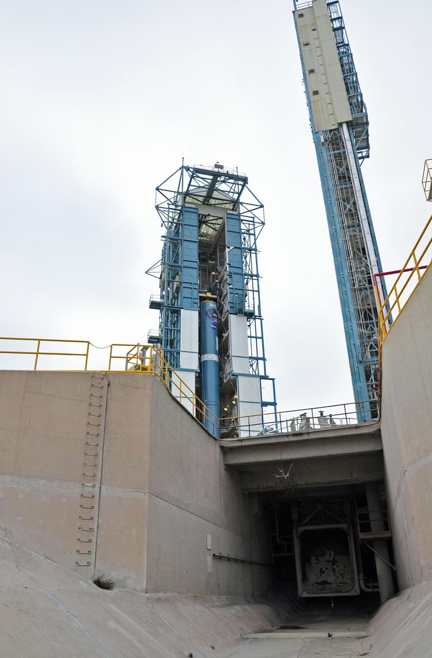 VANDENBERG AIR FORCE BASE, Calif. – This view from the exhaust duct beneath Space Launch Complex 2 on Vandenberg Air Force Base in California reveals the first stage of the United Launch Alliance Delta II rocket for NASA's Soil Moisture Active Passive mission, or SMAP, undergoing processing in the mobile service tower.    SMAP will provide global measurements of soil moisture and its freeze/thaw state. These measurements will be used to enhance understanding of processes that link the water, energy and carbon cycles, and to extend the capabilities of weather and climate prediction models. SMAP data also will be used to quantify net carbon flux in boreal landscapes and to develop improved flood prediction and drought monitoring capabilities. Launch is scheduled for November 2014. To learn more about SMAP, visit http://smap.jpl.nasa.gov.  Photo credit: NASA/Randy Beaudoin