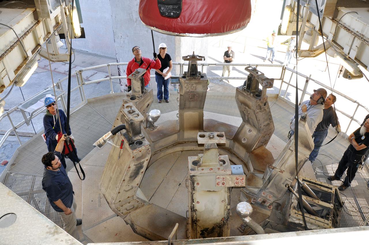 VANDENBERG AIR FORCE BASE, Calif. – The nozzle on the first stage of the United Launch Alliance Delta II rocket for NASA's Soil Moisture Active Passive mission, or SMAP, comes into view as the booster is lowered onto the launcher adjacent to the fixed umbilical tower at Space Launch Complex 2 on Vandenberg Air Force Base in California.    SMAP will provide global measurements of soil moisture and its freeze/thaw state. These measurements will be used to enhance understanding of processes that link the water, energy and carbon cycles, and to extend the capabilities of weather and climate prediction models. SMAP data also will be used to quantify net carbon flux in boreal landscapes and to develop improved flood prediction and drought monitoring capabilities. Launch is scheduled for November 2014. To learn more about SMAP, visit http://smap.jpl.nasa.gov.  Photo credit: NASA/Randy Beaudoin
