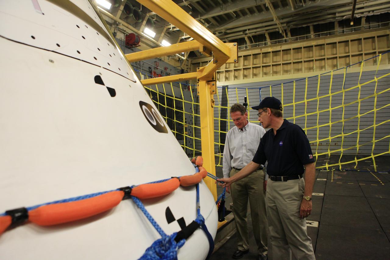 LOS ANGELES, Calif. – Mike Bolger, Ground Systems Development and Operations Program manager, at left, and Mike Generale, Orion Recovery Operations manager and Recovery Test director, both from NASA’s Kennedy Space Center in Florida, talk about Underway Recovery Test 2 in the well deck of the USS Anchorage. The U.S. Navy ship is in Los Angeles for LA Navy Days. NASA, Lockheed Martin and the U.S. Navy completed the recovery test in the Pacific Ocean off the coast of San Diego to prepare for recovery of the Orion crew module on its return from a deep space mission. The underway recovery test allowed the teams to demonstrate and evaluate the recovery processes, procedures, new hardware and personnel in open waters. The Ground Systems Development and Operations Program conducted the underway recovery test. Orion is the exploration spacecraft designed to carry astronauts to destinations not yet explored by humans, including an asteroid and Mars. It will have emergency abort capability, sustain the crew during space travel and provide safe re-entry from deep space return velocities. The first unpiloted test flight of the Orion is scheduled to launch in 2014 atop a Delta IV rocket and in 2017 on NASA’s Space Launch System rocket. For more information, visit http://www.nasa.gov/orion. Photo credit: Kim Shiflett