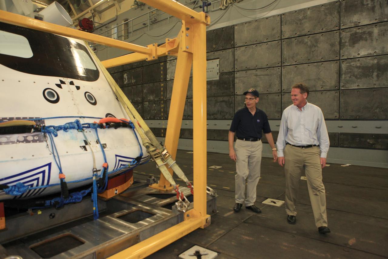 LOS ANGELES, Calif. – Mike Bolger, Ground Systems Development and Operations Program manager, at right, and Mike Generale, Orion Recovery Operations manager and Recovery Test director, both from NASA’s Kennedy Space Center in Florida, view the Orion boilerplate test vehicle in its recovery cradle in the well deck of the USS Anchorage. NASA, Lockheed Martin and the U.S. Navy completed the Orion recovery test in the Pacific Ocean off the coast of San Diego to prepare for recovery of the Orion crew module on its return from a deep space mission. The underway recovery test allowed the teams to demonstrate and evaluate the recovery processes, procedures, new hardware and personnel in open waters. The U.S. Navy ship is in Los Angeles for LA Navy Days. The Ground Systems Development and Operations Program conducted the underway recovery test. Orion is the exploration spacecraft designed to carry astronauts to destinations not yet explored by humans, including an asteroid and Mars. It will have emergency abort capability, sustain the crew during space travel and provide safe re-entry from deep space return velocities. The first unpiloted test flight of the Orion is scheduled to launch in 2014 atop a Delta IV rocket and in 2017 on NASA’s Space Launch System rocket. For more information, visit http://www.nasa.gov/orion. Photo credit: Kim Shiflett