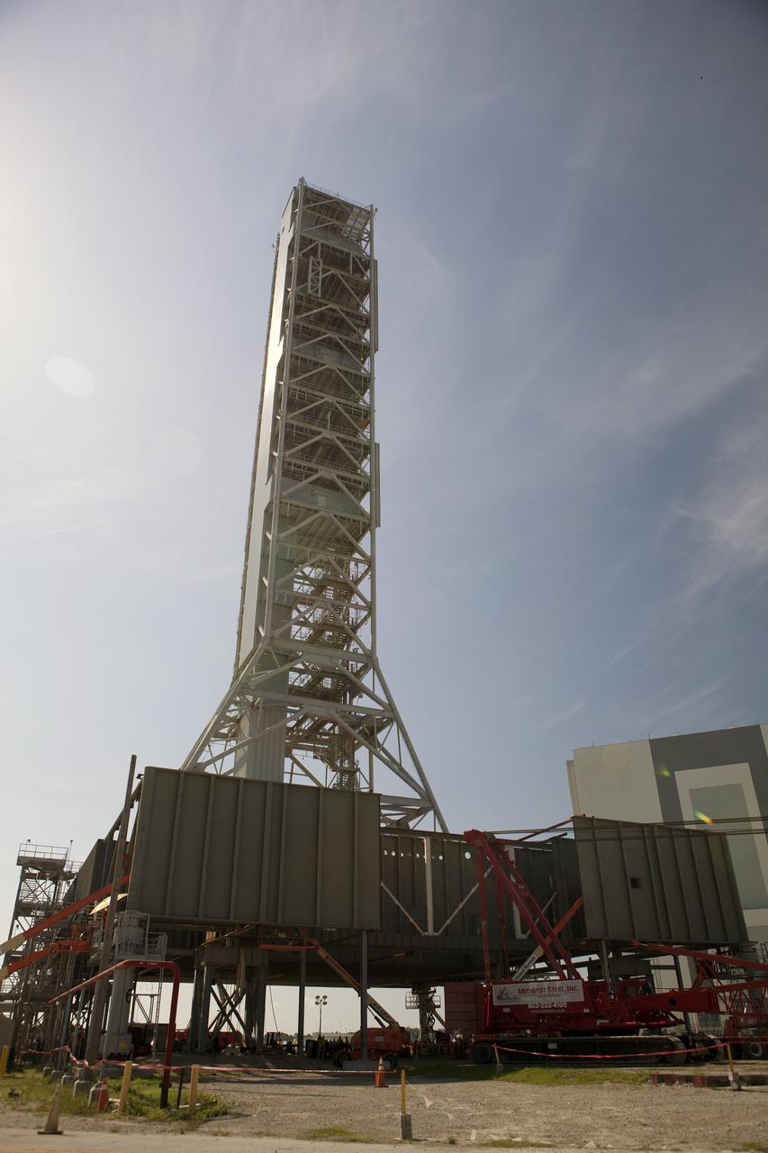 CAPE CANAVERAL, Fla. – Modifications continue on the Mobile Launcher, or ML, at the Mobile Launcher Park Site at NASA’s Kennedy Space Center in Florida. The ML is being modified and strengthened to accommodate the weight, size and thrust at launch of NASA's Space Launch System, or SLS, and Orion spacecraft.    In 2013, the agency awarded a contract to J.P. Donovan Construction Inc. of Rockledge, Fla., to modify the ML, which is one of the key elements of ground support equipment that is being upgraded by the Ground Systems Development and Operations Program at Kennedy. The existing 24-foot exhaust hole is being enlarged and strengthened for the larger, heavier SLS rocket. The ML will carry the SLS rocket and Orion spacecraft to Launch Pad 39B for its first mission, Exploration Mission-1, in 2017. Photo credit: NASA/Dimitri Gerondidakis