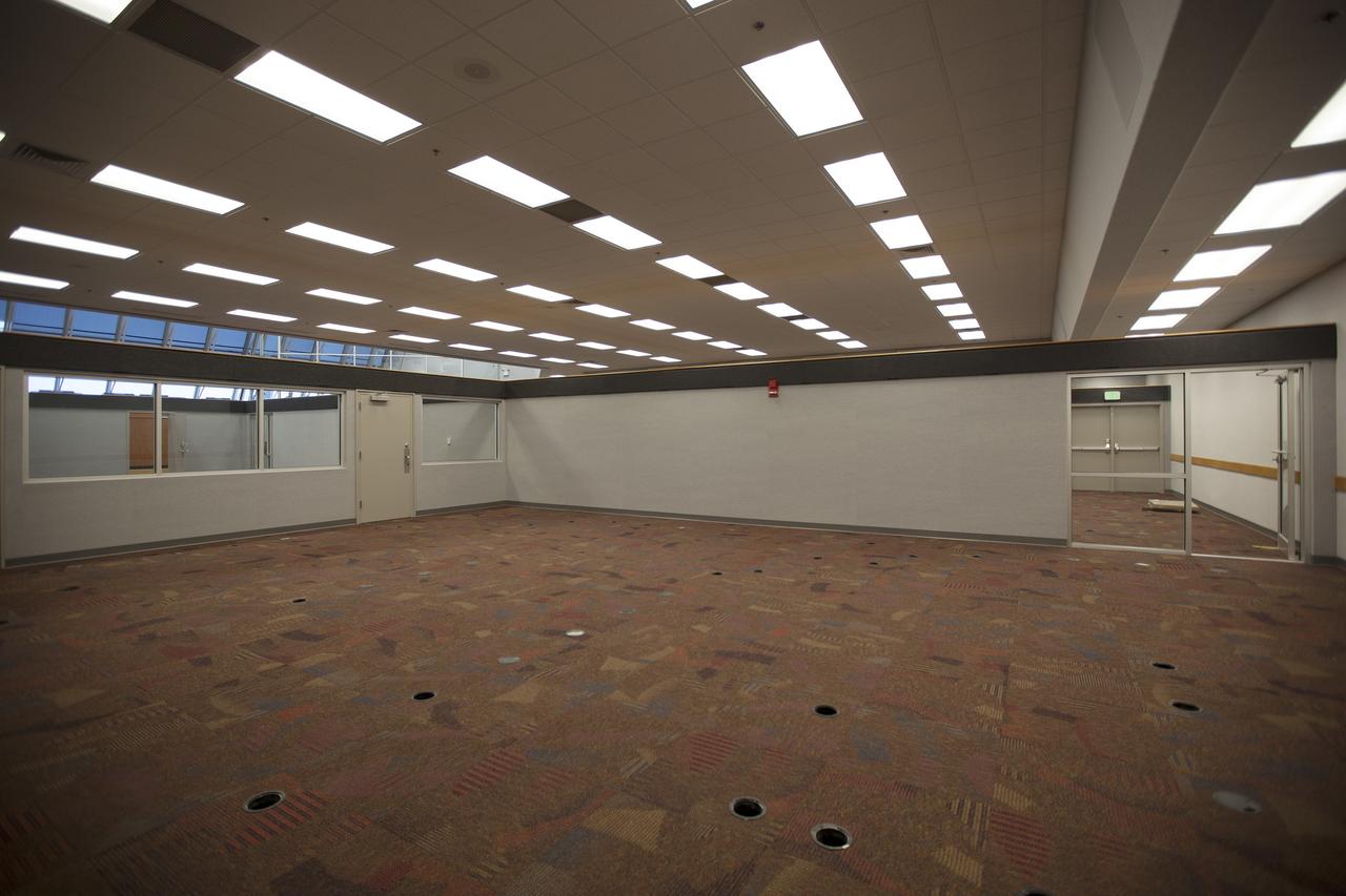 CAPE CANAVERAL, Fla. – Inside Firing Room 4 in the Launch Control Center at NASA's Kennedy Space Center in Florida, the outer walls, inner walls, windows and doors for the four firing rooms have been completed and new carpeting has been installed. Three rows of upper level management consoles remain and could be used as a fifth firing room. The Ground Systems Development and Operations Program is overseeing the efforts to create a new firing room based on a multi-user concept.    The design of Firing Room 4 incorporates five control room areas that can be flexible to meet current and future NASA and commercial user requirements. The equipment and most of the consoles from Firing Room 4 were moved to Firing Room 2 for possible future reuse. Photo credit: NASA/Dimitri Gerondidakis