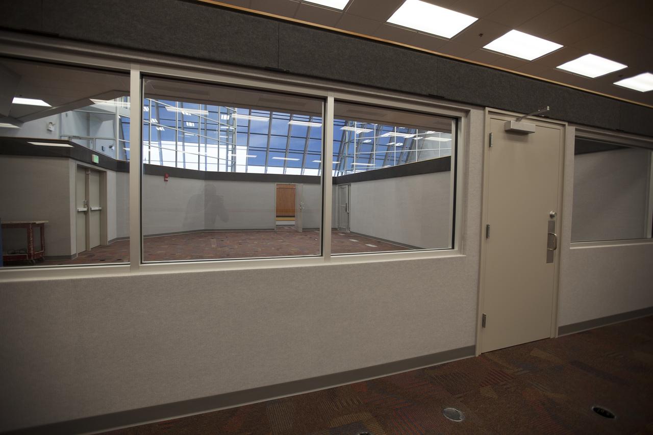 CAPE CANAVERAL, Fla. – A close-up view of one of the individual firing rooms inside Firing Room 4 in the Launch Control Center at NASA's Kennedy Space Center in Florida, reveals the inner walls, outer walls, windows and doors have been completed. New ceiling tiles, lighting and carpeting have been installed. Three rows of upper level management consoles remain and could be used as a fifth firing room. The Ground Systems Development and Operations Program is overseeing the efforts to create a new firing room based on a multi-user concept.     The design of Firing Room 4 incorporates five control room areas that can be flexible to meet current and future NASA and commercial user requirements. The equipment and most of the consoles from Firing Room 4 were moved to Firing Room 2 for possible future reuse. Photo credit: NASA/Dimitri Gerondidakis