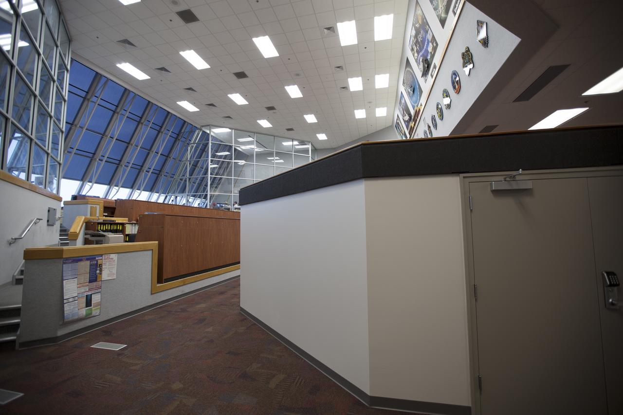 CAPE CANAVERAL, Fla. – Inside Firing Room 4 in the Launch Control Center at NASA's Kennedy Space Center in Florida, the inner walls, outer walls, windows and doors have been completed for the four individual firing rooms. New ceiling tiles, lighting and carpeting have been installed. Three rows of upper level management consoles remain and could be used as a fifth firing room. The Ground Systems Development and Operations Program is overseeing the efforts to create a new firing room based on a multi-user concept.  The space shuttle plaques and posters remain on the wall above the firing rooms.    The design of Firing Room 4 incorporates five control room areas that can be flexible to meet current and future NASA and commercial user requirements. The equipment and most of the consoles from Firing Room 4 were moved to Firing Room 2 for possible future reuse. Photo credit: NASA/Dimitri Gerondidakis