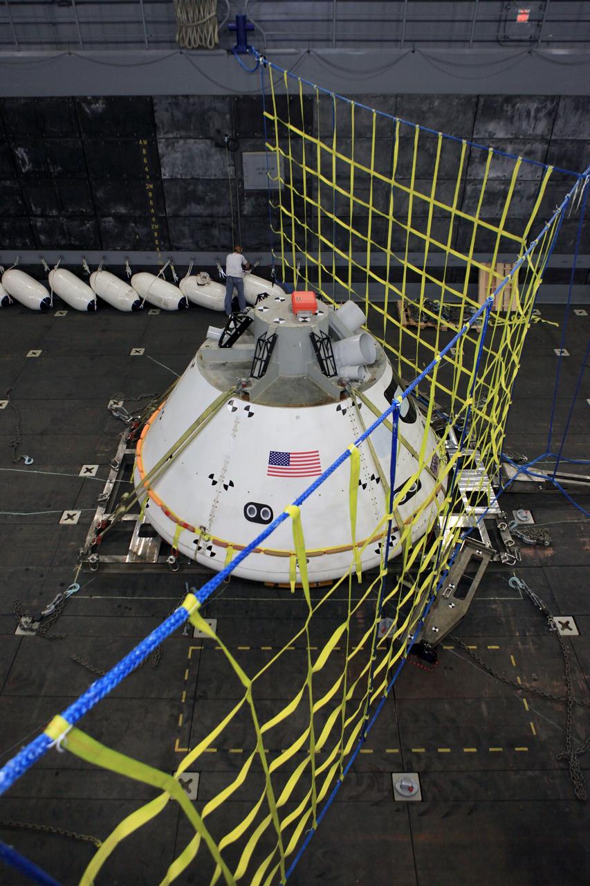 SAN DIEGO, Calif. – The Orion boilerplate test vehicle is secured on its cradle in the well deck of the U.S. Navy's USS Anchorage in preparation for Underway Recovery Test 2 in the Pacific Ocean off the coast of San Diego. A safety barrier has been installed near the test vehicle to keep it from moving further into the well deck as it fills with water. NASA, Lockheed Martin and the U.S. Navy will conduct the test to prepare for recovery of the Orion crew module on its return from a deep space mission. The underway recovery test will allow the team to demonstrate and evaluate the recovery processes, procedures, new hardware and personnel in open waters.    The Ground Systems Development and Operations Program is conducting the underway recovery test. Orion is the exploration spacecraft designed to carry astronauts to destinations not yet explored by humans, including an asteroid and Mars. It will have emergency abort capability, sustain the crew during space travel and provide safe re-entry from deep space return velocities. The first unpiloted test flight of the Orion is scheduled to launch in 2014 atop a Delta IV rocket and in 2017 on NASA’s Space Launch System rocket. For more information, visit http://www.nasa.gov/orion. Photo credit: NASA/Kim Shiflett