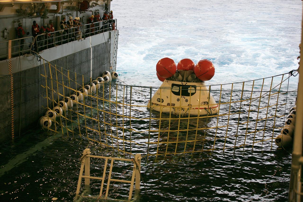 SAN DIEGO, Calif. – Inside the U.S. Navy’s USS Anchorage, NASA, Lockheed Martin and U.S. Navy personnel watch as the well deck fills with water around the Orion boilerplate test vehicle during a portion of Underway Recovery Test 2 in the Pacific Ocean off the coast of San Diego. Tether lines are attached to the test vehicle and a safety barrier has been installed to prevent Orion from going further into the well deck. The test will help the team to prepare for recovery of the Orion crew module on its return from a deep space mission. The underway recovery test will allow the team to demonstrate and evaluate the recovery processes, procedures, new hardware and personnel in open waters.     The Ground Systems Development and Operations Program is conducting the underway recovery test. Orion is the exploration spacecraft designed to carry astronauts to destinations not yet explored by humans, including an asteroid and Mars. It will have emergency abort capability, sustain the crew during space travel and provide safe re-entry from deep space return velocities. The first unpiloted test flight of the Orion is scheduled to launch in 2014 atop a Delta IV rocket and in 2017 on NASA’s Space Launch System rocket. For more information, visit http://www.nasa.gov/orion. Photo credit: NASA/Kim Shiflett