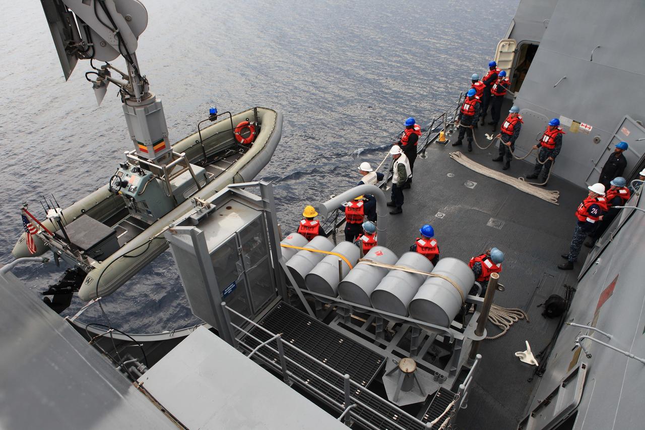 SAN DIEGO, Calif. – U.S. Navy personnel on the top deck of the USS Anchorage watch as a crane is used to lower a rigid hull inflatable boat into the water in preparation for Orion Underway Recovery Test 2. NASA, Lockheed Martin and the U.S. Navy are conducting the test on the Orion boilerplate test vehicle in the Pacific Ocean off the coast of San Diego to prepare for recovery of the Orion crew module on its return from a deep space mission. The underway recovery test will allow the team to demonstrate and evaluate the recovery processes, procedures, new hardware and personnel in open waters.     The Ground Systems Development and Operations Program is conducting the underway recovery test. Orion is the exploration spacecraft designed to carry astronauts to destinations not yet explored by humans, including an asteroid and Mars. It will have emergency abort capability, sustain the crew during space travel and provide safe re-entry from deep space return velocities. The first unpiloted test flight of the Orion is scheduled to launch in 2014 atop a Delta IV rocket and in 2017 on NASA’s Space Launch System rocket. For more information, visit http://www.nasa.gov/orion. Photo credit: NASA/Kim Shiflett
