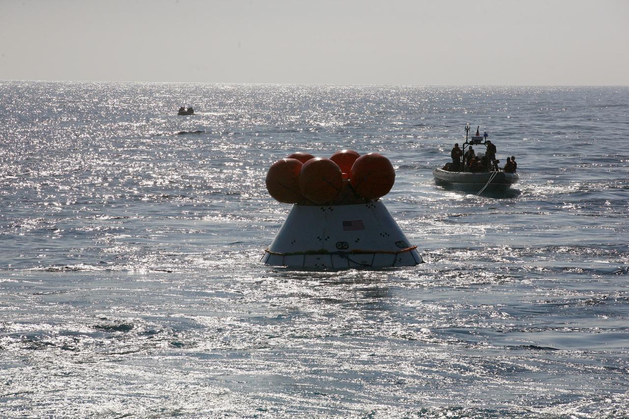 SAN DIEGO, Calif. – The Orion boilerplate test vehicle floats freely in the Pacific Ocean off the coast of San Diego during a portion of the Underway Recovery Test 2. Nearby, U.S. Navy personnel in a rigid hull inflatable boat monitor Orion.     The testing is being conducted to prepare for recovery of the Orion crew module on its return from a deep-space mission. The underway recovery test will allow the team to demonstrate and evaluate the recovery processes, procedures, new hardware and personnel in open waters. The Ground Systems Development and Operations Program is conducting the underway recovery test. Orion is the exploration spacecraft designed to carry astronauts to destinations not yet explored by humans, including an asteroid and Mars. It will have emergency abort capability, sustain the crew during space travel and provide safe re-entry from deep-space return velocities. The first unpiloted test flight of the Orion is scheduled to launch in 2014 atop a Delta IV rocket and in 2017 on NASA’s Space Launch System rocket. For more information, visit http://www.nasa.gov/orion. Photo credit: NASA/Kim Shiflett