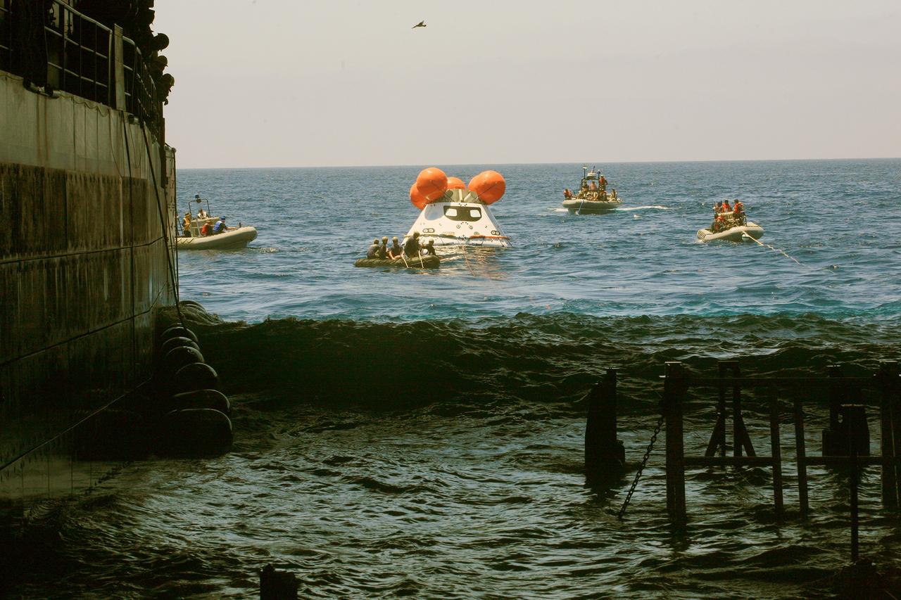 SAN DIEGO, Calif. – A view from inside the well deck of the USS Anchorage reveals U.S. Navy personnel in rigid hull inflatable boats attaching tether lines to NASA’s Orion boilerplate test article as it floats in the Pacific Ocean off the coast of San Diego during a portion of the Underway Recovery Test 2.    The testing is being conducted to prepare for recovery of the Orion crew module on its return from a deep-space mission. The underway recovery test will allow the team to demonstrate and evaluate the recovery processes, procedures, new hardware and personnel in open waters. The Ground Systems Development and Operations Program is conducting the underway recovery test. Orion is the exploration spacecraft designed to carry astronauts to destinations not yet explored by humans, including an asteroid and Mars. It will have emergency abort capability, sustain the crew during space travel and provide safe re-entry from deep-space return velocities. The first unpiloted test flight of the Orion is scheduled to launch in 2014 atop a Delta IV rocket and in 2017 on NASA’s Space Launch System rocket. For more information, visit http://www.nasa.gov/orion. Photo credit: NASA/Kim Shiflett