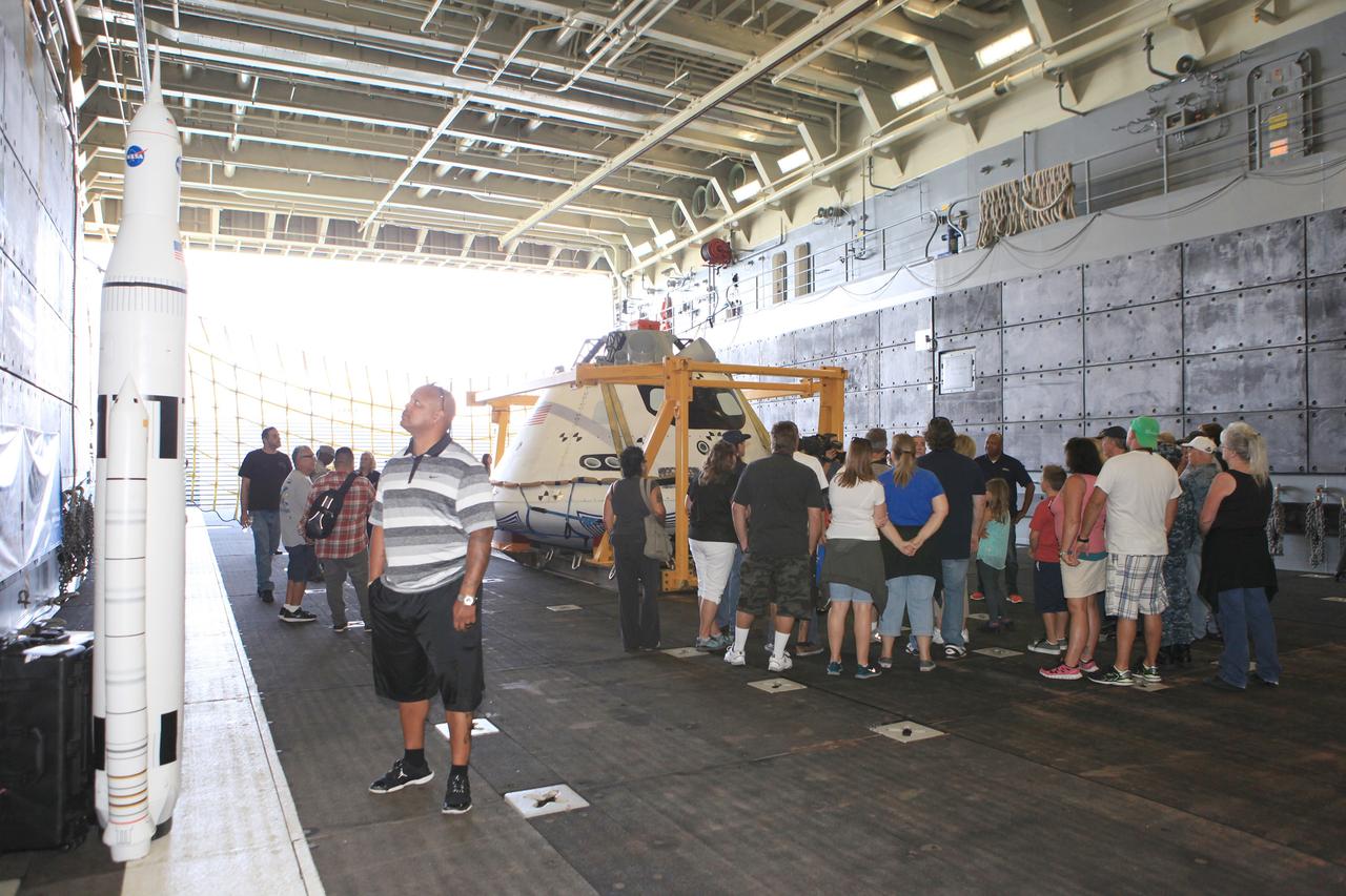 LOS ANGELES, Calif. – Visitors tour the well deck of the USS Anchorage and view the Orion boilerplate test vehicle secured in its recovery cradle during the Science, Technology, Engineering and Mathematics, or STEM, Expo for L.A. Navy Days at the Port of Los Angeles in California.    A combined team from NASA’s Ground Systems Development and Operations Program and the U.S. Navy were in San Diego to practice recovering Orion from the ocean, as they will do in December following the spacecraft's first trip to space during Exploration Flight Test-1. Orion is the exploration spacecraft designed to carry astronauts to destinations not yet explored by humans, including an asteroid and Mars. It will have emergency abort capability, sustain the crew during space travel and provide safe re-entry from deep-space return velocities. The first unpiloted test flight of the Orion is scheduled to launch in 2014 atop a Delta IV rocket and in 2017 on NASA’s Space Launch System rocket. For more information, visit http://www.nasa.gov/orion. Photo credit: NASA/Kim Shiflett