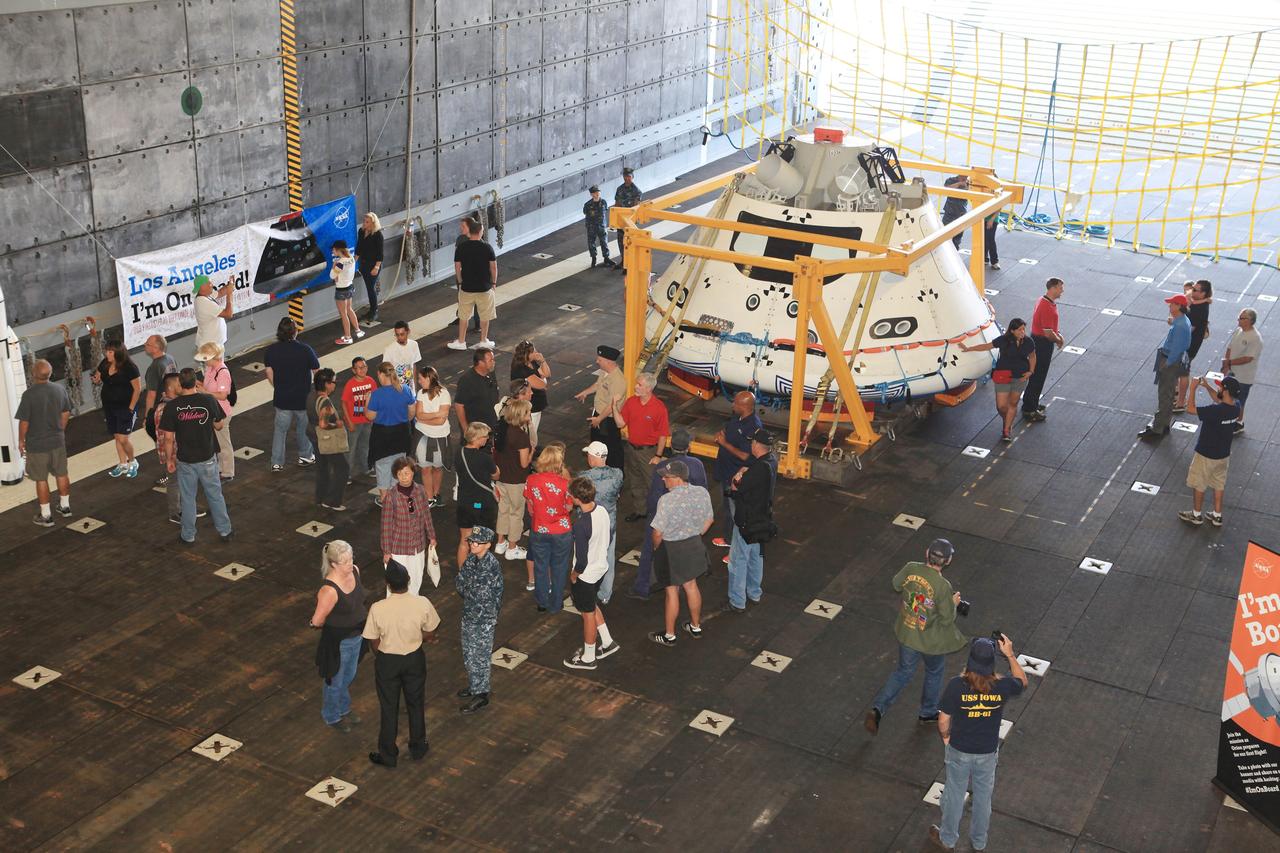 LOS ANGELES, Calif. – Andy Quiett, Detachment 3 deputy operations lead for the Orion program and DoD liaison for NASA, answers questions about the Orion boilerplate test vehicle from visitors touring the well deck of the USS Anchorage during the Science, Technology, Engineering and Mathematics, or STEM, Expo for L.A. Navy Days at the Port of Los Angeles in California.    A combined team from NASA’s Ground Systems Development and Operations Program and the U.S. Navy were in San Diego to practice recovering Orion from the ocean, as they will do in December following the spacecraft's first trip to space during Exploration Flight Test-1. Orion is the exploration spacecraft designed to carry astronauts to destinations not yet explored by humans, including an asteroid and Mars. It will have emergency abort capability, sustain the crew during space travel and provide safe re-entry from deep-space return velocities. The first unpiloted test flight of the Orion is scheduled to launch in 2014 atop a Delta IV rocket and in 2017 on NASA’s Space Launch System rocket. For more information, visit http://www.nasa.gov/orion. Photo credit: NASA/Kim Shiflett