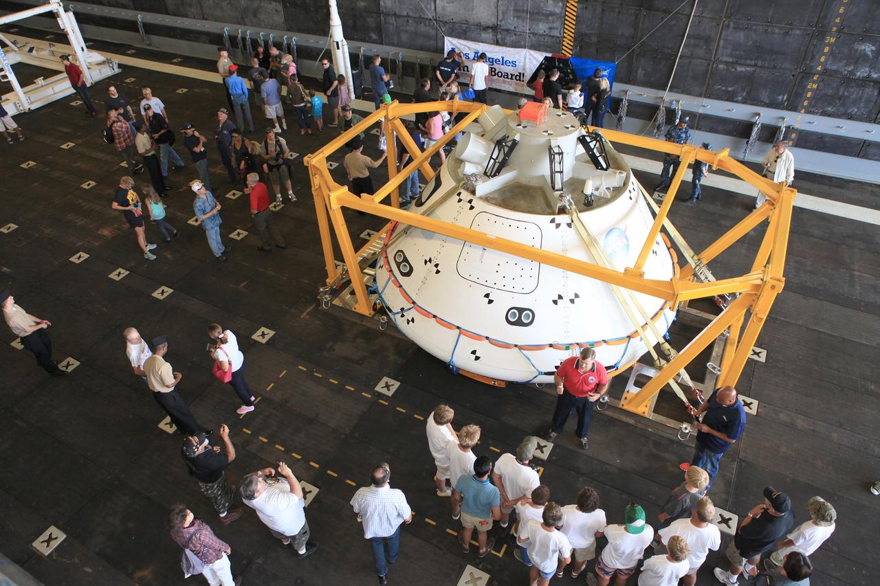 LOS ANGELES, Calif. – Andy Quiett, Detachment 3 deputy operations lead for the Orion program and DoD liaison for NASA, answers questions about the Orion boilerplate test vehicle from visitors touring the well deck of the USS Anchorage during the Science, Technology, Engineering and Mathematics, or STEM, Expo for L.A. Navy Days at the Port of Los Angeles in California.    A combined team from NASA’s Ground Systems Development and Operations Program and the U.S. Navy were in San Diego to practice recovering Orion from the ocean, as they will do in December following the spacecraft's first trip to space during Exploration Flight Test-1. Orion is the exploration spacecraft designed to carry astronauts to destinations not yet explored by humans, including an asteroid and Mars. It will have emergency abort capability, sustain the crew during space travel and provide safe re-entry from deep-space return velocities. The first unpiloted test flight of the Orion is scheduled to launch in 2014 atop a Delta IV rocket and in 2017 on NASA’s Space Launch System rocket. For more information, visit http://www.nasa.gov/orion. Photo credit: NASA/Kim Shiflett