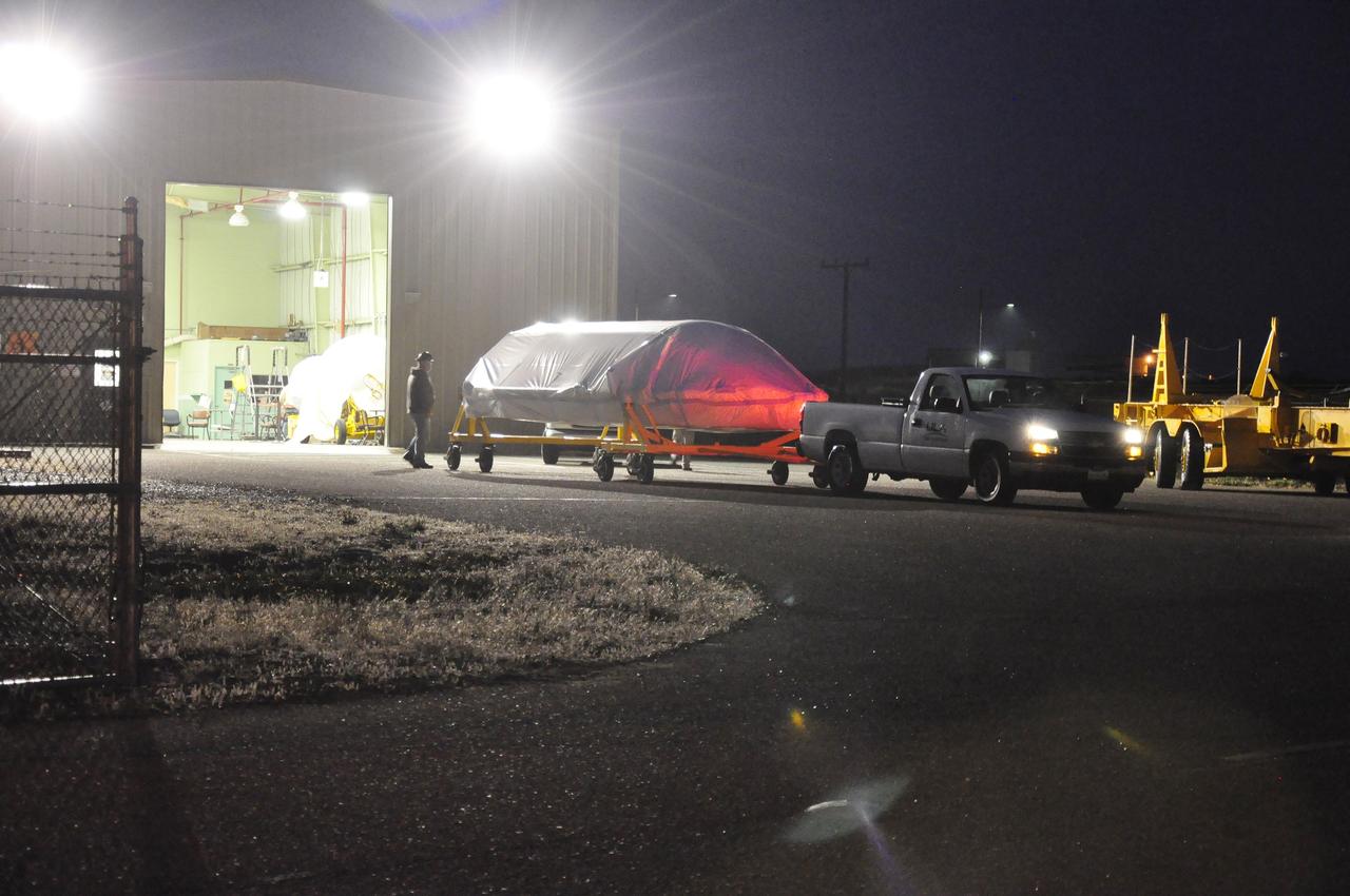 VANDENBERG AIR FORCE BASE, Calif. – A half section of the 10-foot-diameter fairing for NASA's Soil Moisture Active Passive mission, or SMAP, rolls out of the Horizontal Integration Facility bound for the nearby mobile service tower at Space Launch Complex 2 on Vandenberg Air Force Base in California.    The fairing will protect the SMAP spacecraft from the heat and aerodynamic pressure generated during its ascent to orbit aboard a United Launch Alliance Delta II rocket. SMAP will provide global measurements of soil moisture and its freeze/thaw state. These measurements will be used to enhance understanding of processes that link the water, energy and carbon cycles, and to extend the capabilities of weather and climate prediction models. SMAP data will also be used to quantify net carbon flux in boreal landscapes and to develop improved flood prediction and drought monitoring capabilities. Launch is scheduled for no earlier than November 2014. To learn more about SMAP, visit http://smap.jpl.nasa.gov.  Photo credit: NASA/Randy Beaudoin