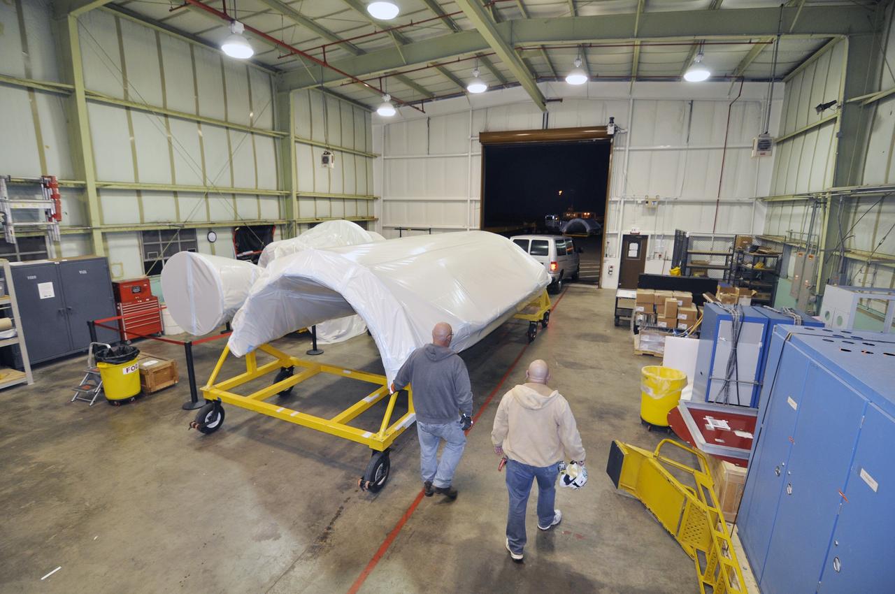 VANDENBERG AIR FORCE BASE, Calif. – Preparations are underway to transport a half section of the 10-foot-diameter fairing for NASA's Soil Moisture Active Passive mission, or SMAP, from the Horizontal Integration Facility to the nearby mobile service tower at Space Launch Complex 2 on Vandenberg Air Force Base in California.    The fairing will protect the SMAP spacecraft from the heat and aerodynamic pressure generated during its ascent to orbit aboard a United Launch Alliance Delta II rocket. SMAP will provide global measurements of soil moisture and its freeze/thaw state. These measurements will be used to enhance understanding of processes that link the water, energy and carbon cycles, and to extend the capabilities of weather and climate prediction models. SMAP data will also be used to quantify net carbon flux in boreal landscapes and to develop improved flood prediction and drought monitoring capabilities. Launch is scheduled for no earlier than November 2014. To learn more about SMAP, visit http://smap.jpl.nasa.gov.  Photo credit: NASA/Randy Beaudoin