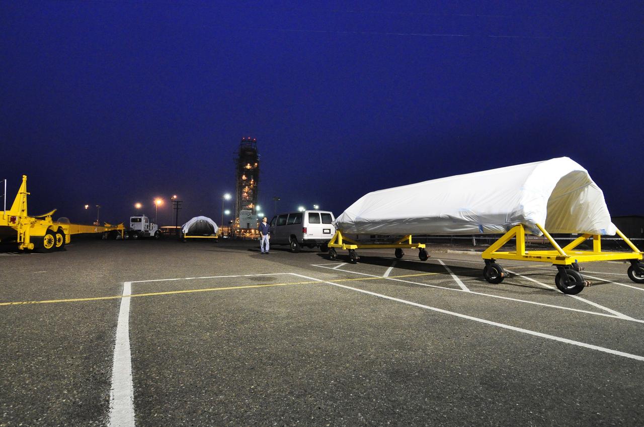 VANDENBERG AIR FORCE BASE, Calif. – The half sections of the 10-foot-diameter fairing for NASA's Soil Moisture Active Passive mission, or SMAP, are delivered to the mobile service tower at Space Launch Complex 2 on Vandenberg Air Force Base in California. The fairing will protect the SMAP spacecraft from the heat and aerodynamic pressure generated during its ascent to orbit aboard a United Launch Alliance Delta II rocket. SMAP will provide global measurements of soil moisture and its freeze/thaw state. These measurements will be used to enhance understanding of processes that link the water, energy and carbon cycles, and to extend the capabilities of weather and climate prediction models. SMAP data will also be used to quantify net carbon flux in boreal landscapes and to develop improved flood prediction and drought monitoring capabilities. Launch is scheduled for no earlier than November 2014. To learn more about SMAP, visit http://smap.jpl.nasa.gov. Photo credit: NASA/Randy Beaudoin