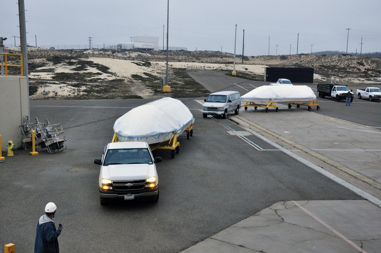 VANDENBERG AIR FORCE BASE, Calif. – The half sections of the 10-foot-diameter fairing for NASA's Soil Moisture Active Passive mission, or SMAP, arrive at the mobile service tower at Space Launch Complex 2 on Vandenberg Air Force Base in California. The fairing will protect the SMAP spacecraft from the heat and aerodynamic pressure generated during its ascent to orbit aboard a United Launch Alliance Delta II rocket. SMAP will provide global measurements of soil moisture and its freeze/thaw state. These measurements will be used to enhance understanding of processes that link the water, energy and carbon cycles, and to extend the capabilities of weather and climate prediction models. SMAP data will also be used to quantify net carbon flux in boreal landscapes and to develop improved flood prediction and drought monitoring capabilities. Launch is scheduled for no earlier than November 2014. To learn more about SMAP, visit http://smap.jpl.nasa.gov. Photo credit: NASA/Randy Beaudoin