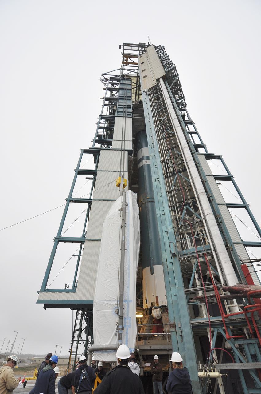 VANDENBERG AIR FORCE BASE, Calif. – A half section of the 10-foot-diameter fairing for NASA's Soil Moisture Active Passive mission, or SMAP, is hoisted up the side of the mobile service tower at Space Launch Complex 2 on Vandenberg Air Force Base in California, past the Delta II first stage.    The fairing will protect the SMAP spacecraft from the heat and aerodynamic pressure generated during its ascent to orbit aboard a United Launch Alliance Delta II rocket. SMAP will provide global measurements of soil moisture and its freeze/thaw state. These measurements will be used to enhance understanding of processes that link the water, energy and carbon cycles, and to extend the capabilities of weather and climate prediction models. SMAP data will also be used to quantify net carbon flux in boreal landscapes and to develop improved flood prediction and drought monitoring capabilities. Launch is scheduled for no earlier than November 2014. To learn more about SMAP, visit http://smap.jpl.nasa.gov.  Photo credit: NASA/Randy Beaudoin