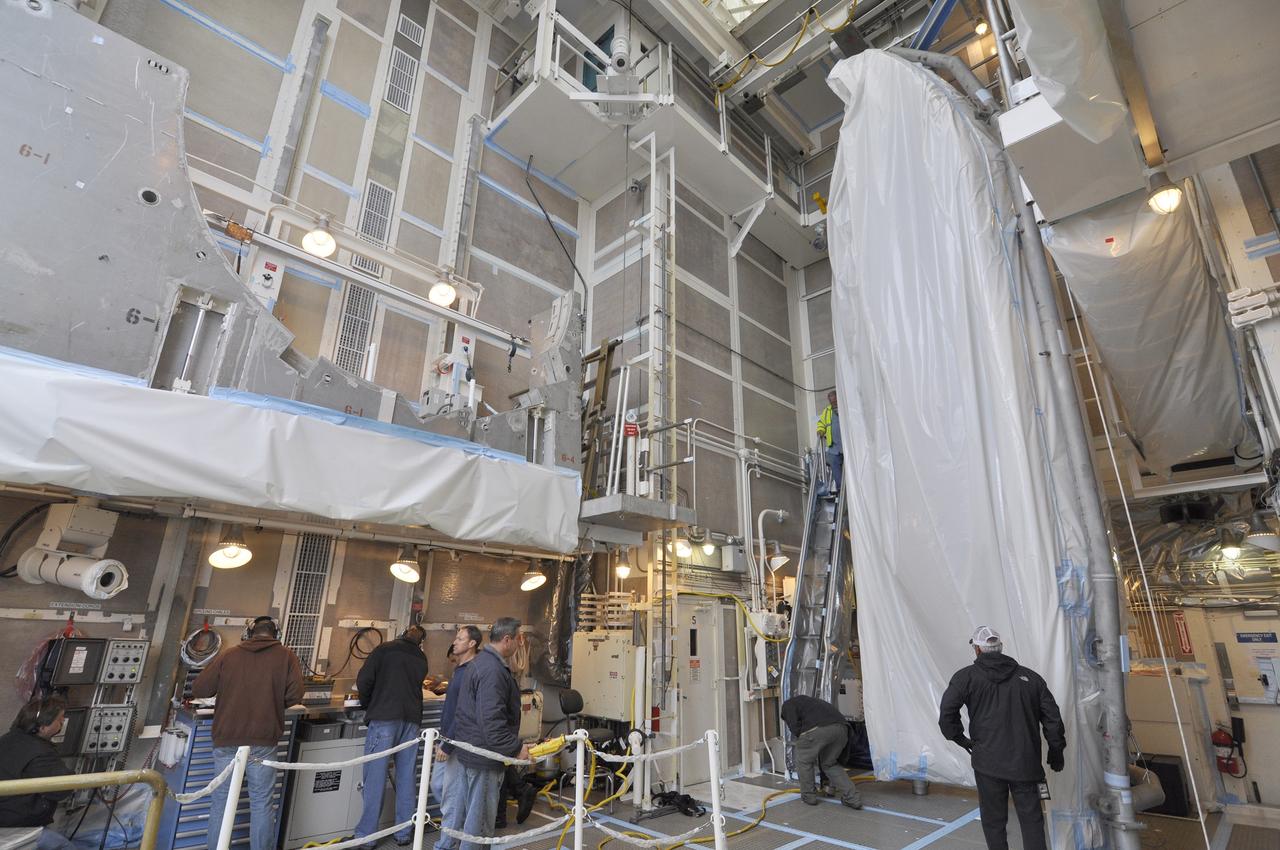 VANDENBERG AIR FORCE BASE, Calif. – A half section of the 10-foot-diameter fairing for NASA's Soil Moisture Active Passive mission, or SMAP, is stowed in the environmental enclosure at the top of the mobile service tower at Space Launch Complex 2 on Vandenberg Air Force Base in California until the arrival of the spacecraft.    The fairing will protect the SMAP spacecraft from the heat and aerodynamic pressure generated during its ascent to orbit aboard a United Launch Alliance Delta II rocket. SMAP will provide global measurements of soil moisture and its freeze/thaw state. These measurements will be used to enhance understanding of processes that link the water, energy and carbon cycles, and to extend the capabilities of weather and climate prediction models. SMAP data will also be used to quantify net carbon flux in boreal landscapes and to develop improved flood prediction and drought monitoring capabilities. Launch is scheduled for no earlier than November 2014. To learn more about SMAP, visit http://smap.jpl.nasa.gov.  Photo credit: NASA/Randy Beaudoin